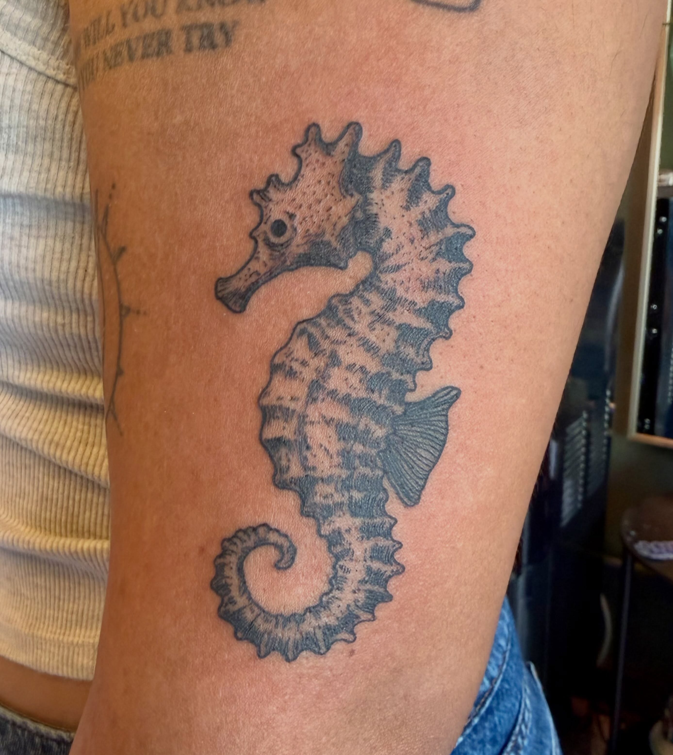 Seahorse black and grey tattoo on the thigh by Patrick Carroll