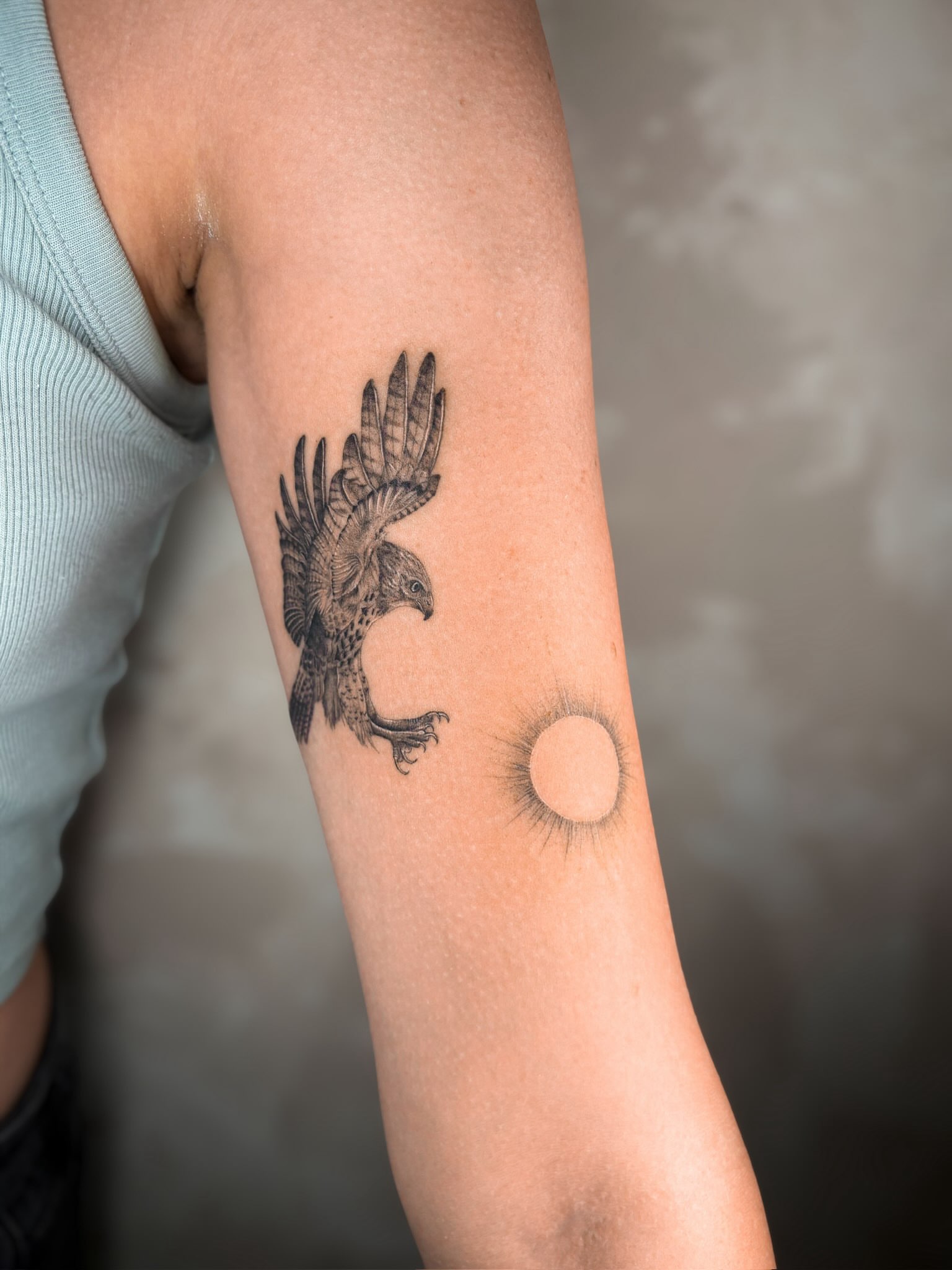 Hawk black and grey tattoo on the forearm by Annie