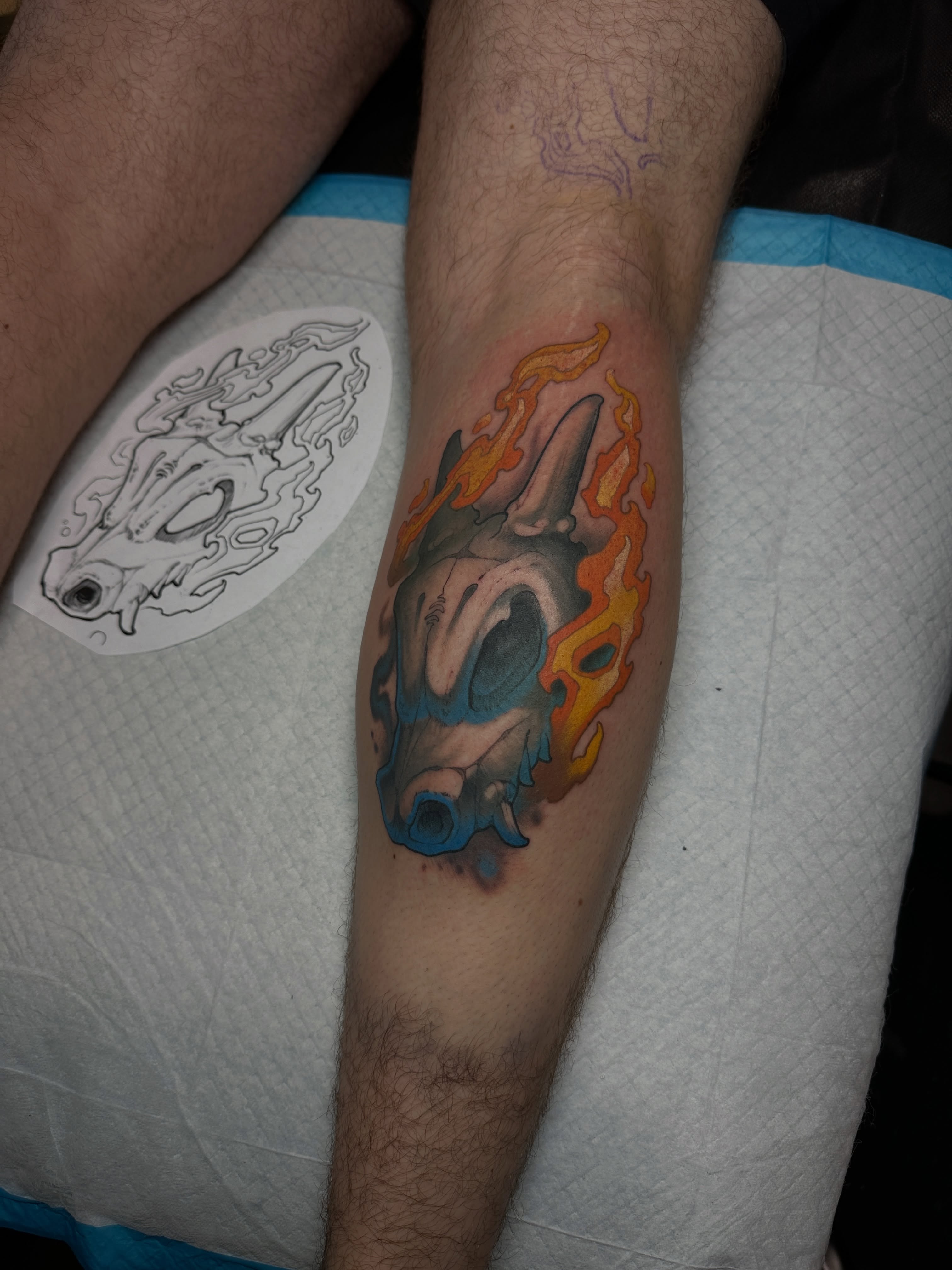 Bull skull with flames realism tattoo on the forearm by Skylar Mangrum