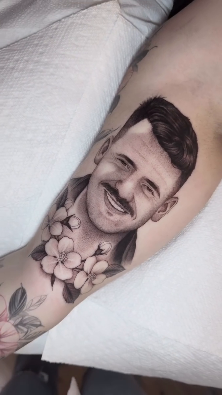 Portrait of a man with flowers realism tattoo by Luna Lucero