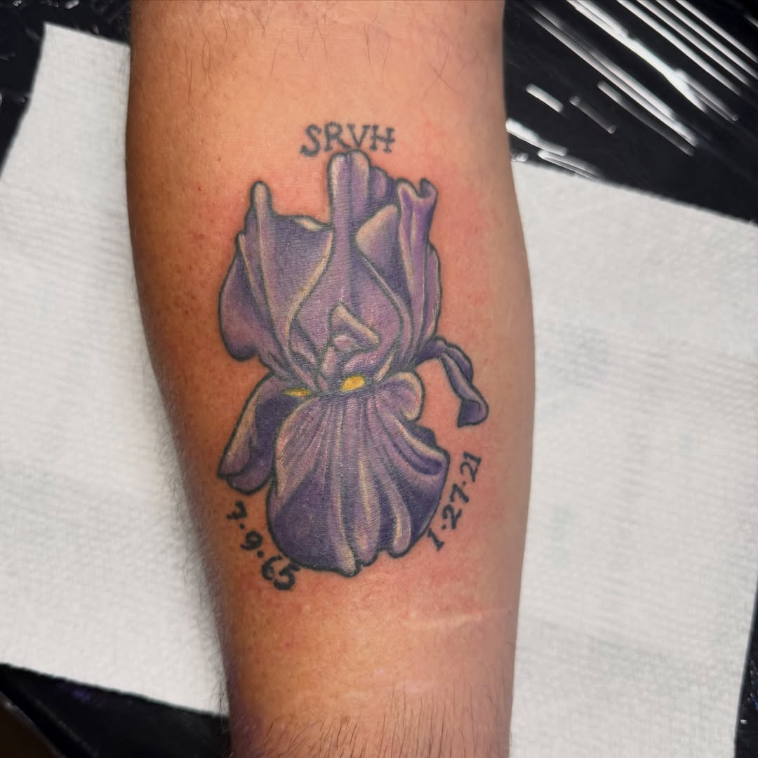 Purple iris realism tattoo on the forearm by Lauren Horness