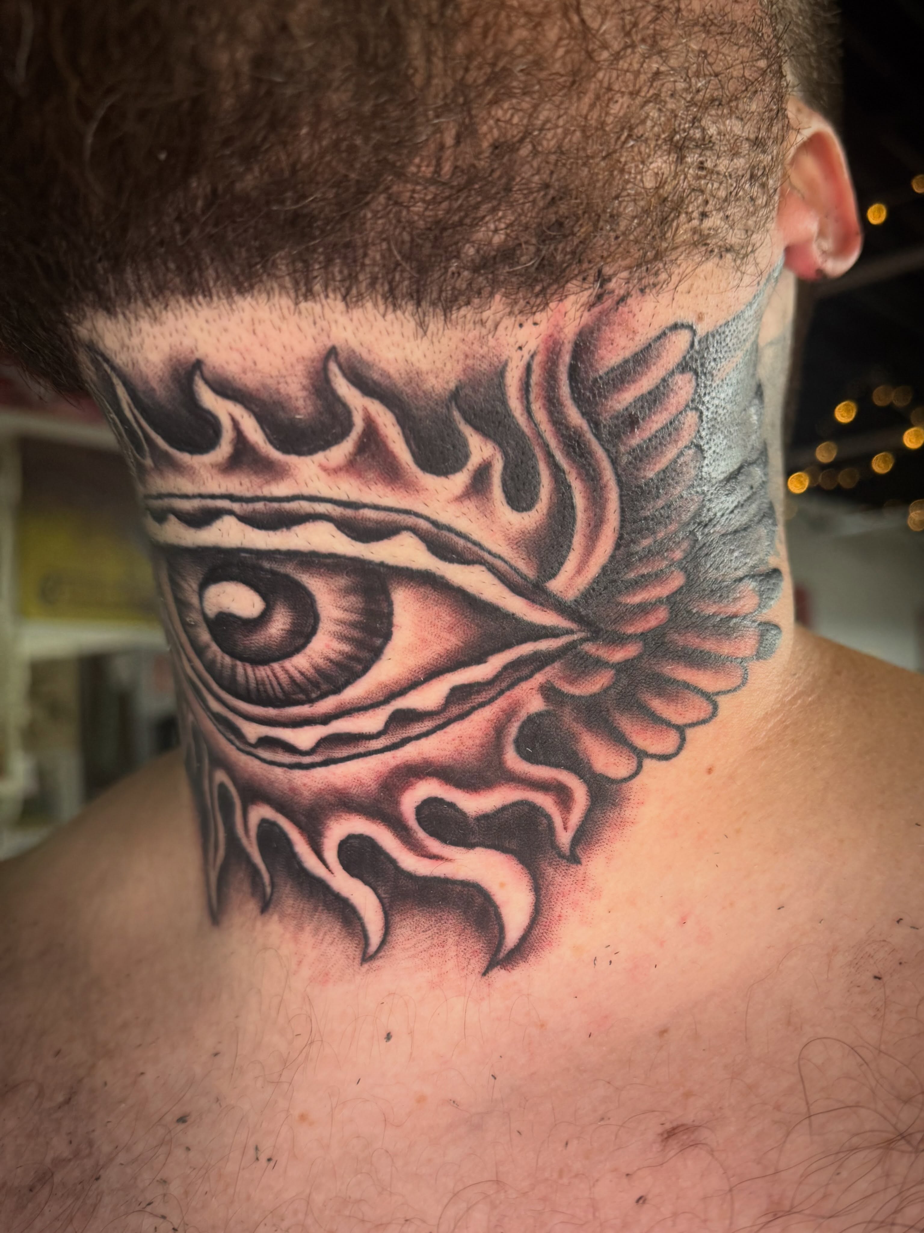 Eye with flames tribal tattoo on the neck by Jake Horstman, Dayton, Ohio
