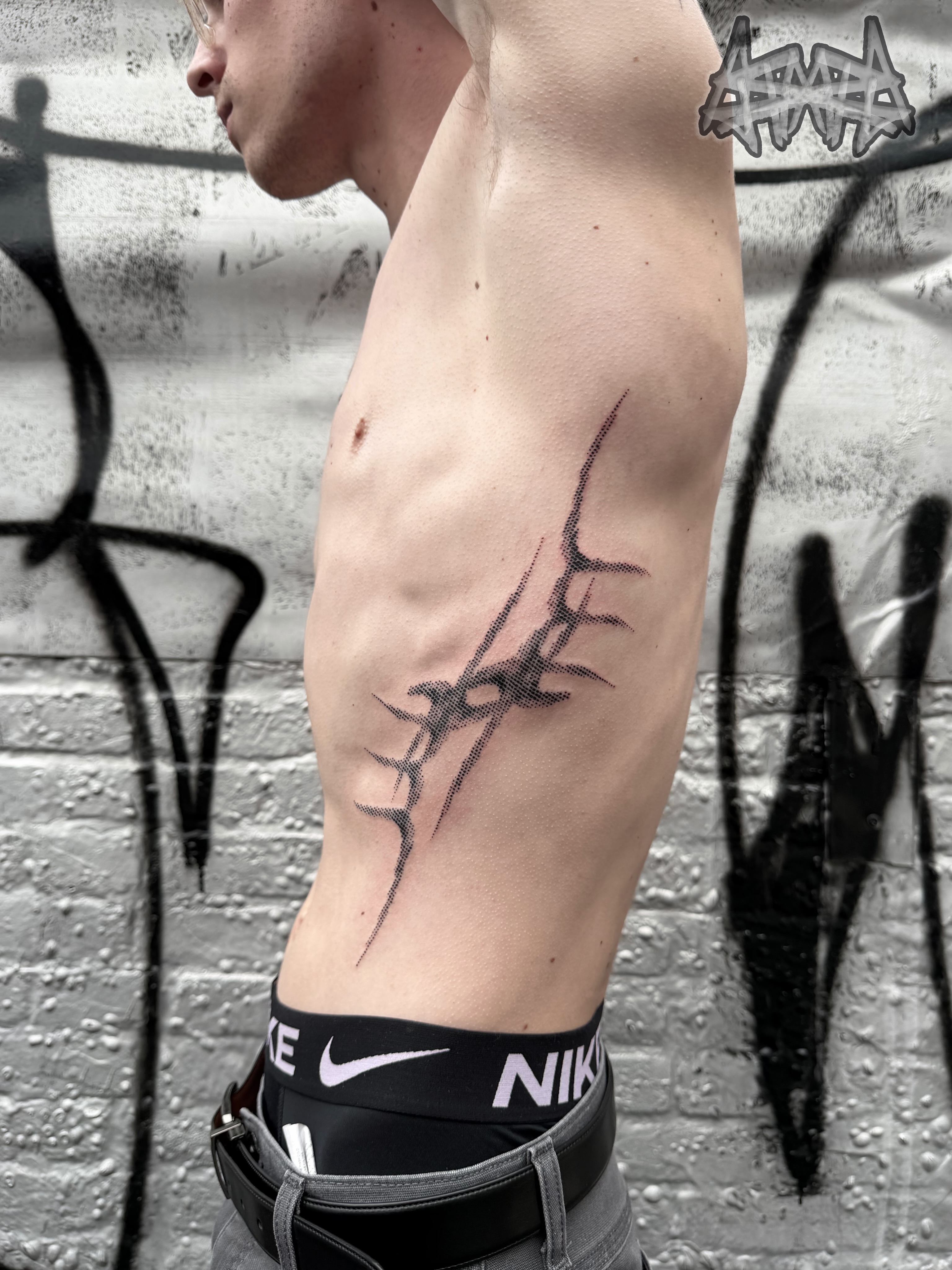 Barbed wire dotwork tattoo on the ribs by Haza