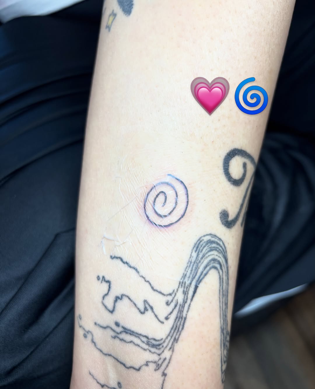 Swirls and heart geometric tattoo on the forearm by riley