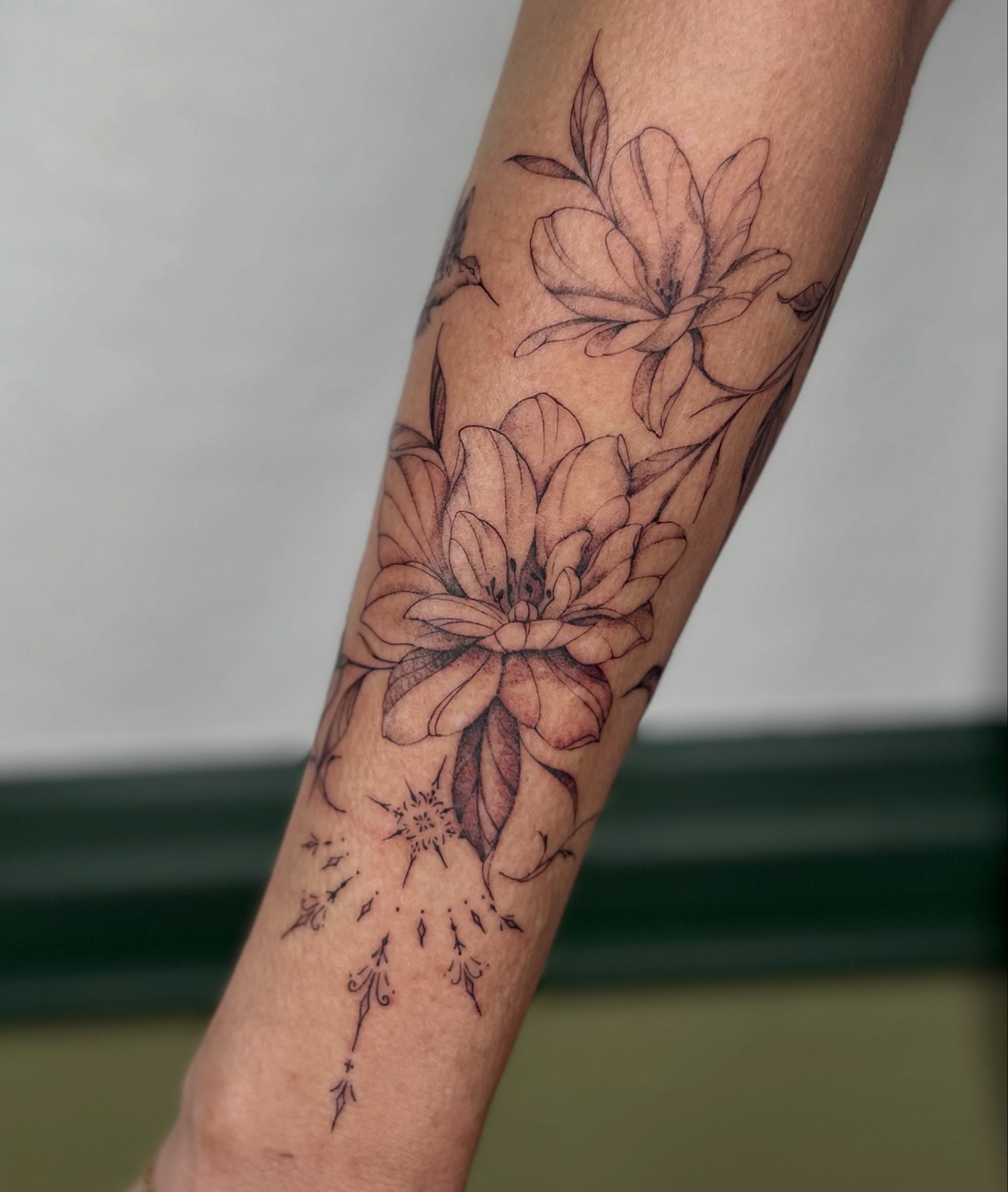 Floral arrangement black and grey tattoo on the forearm by Ash F