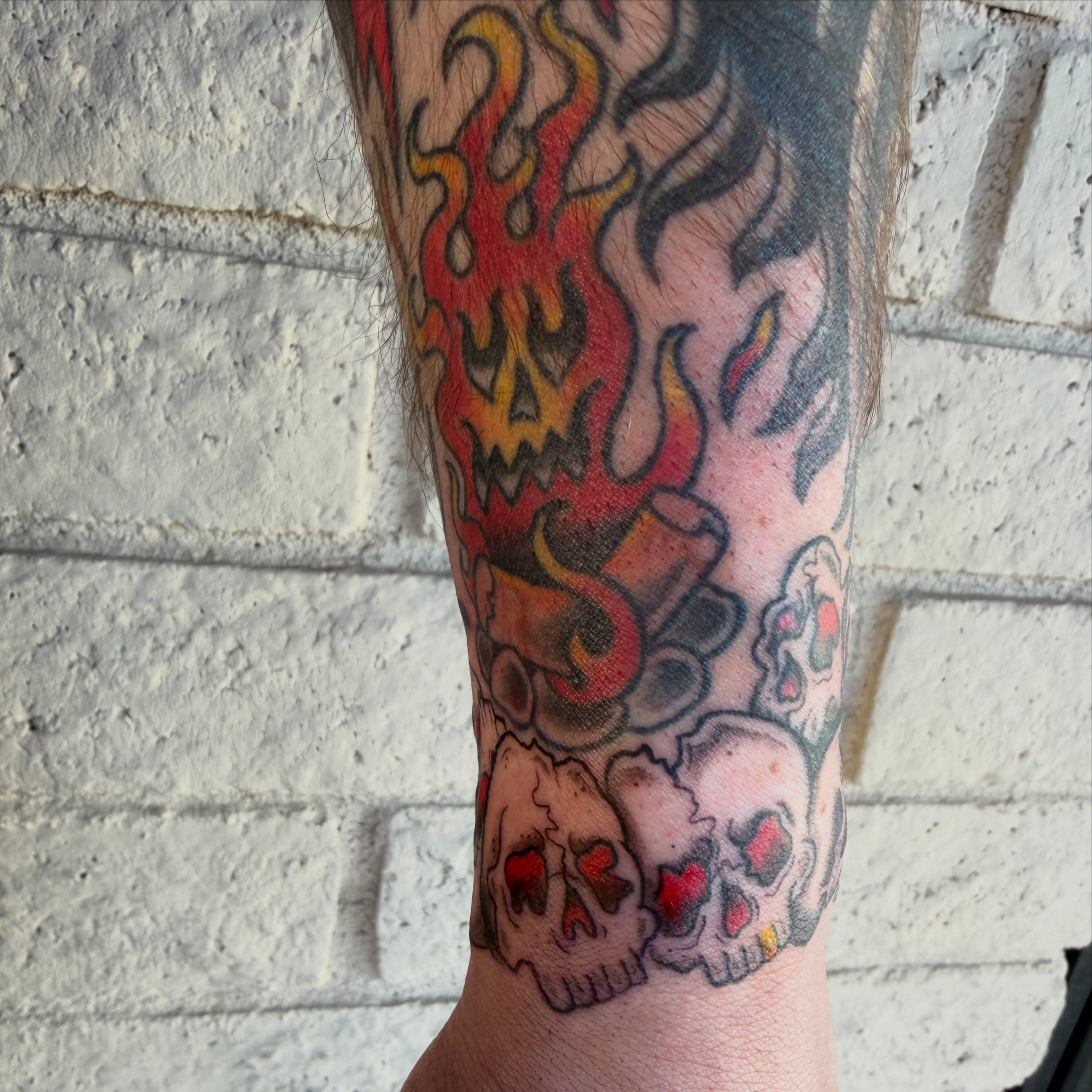 Flaming skulls American traditional tattoo on the forearm by Kayla Jackson, Phoenix, Arizona