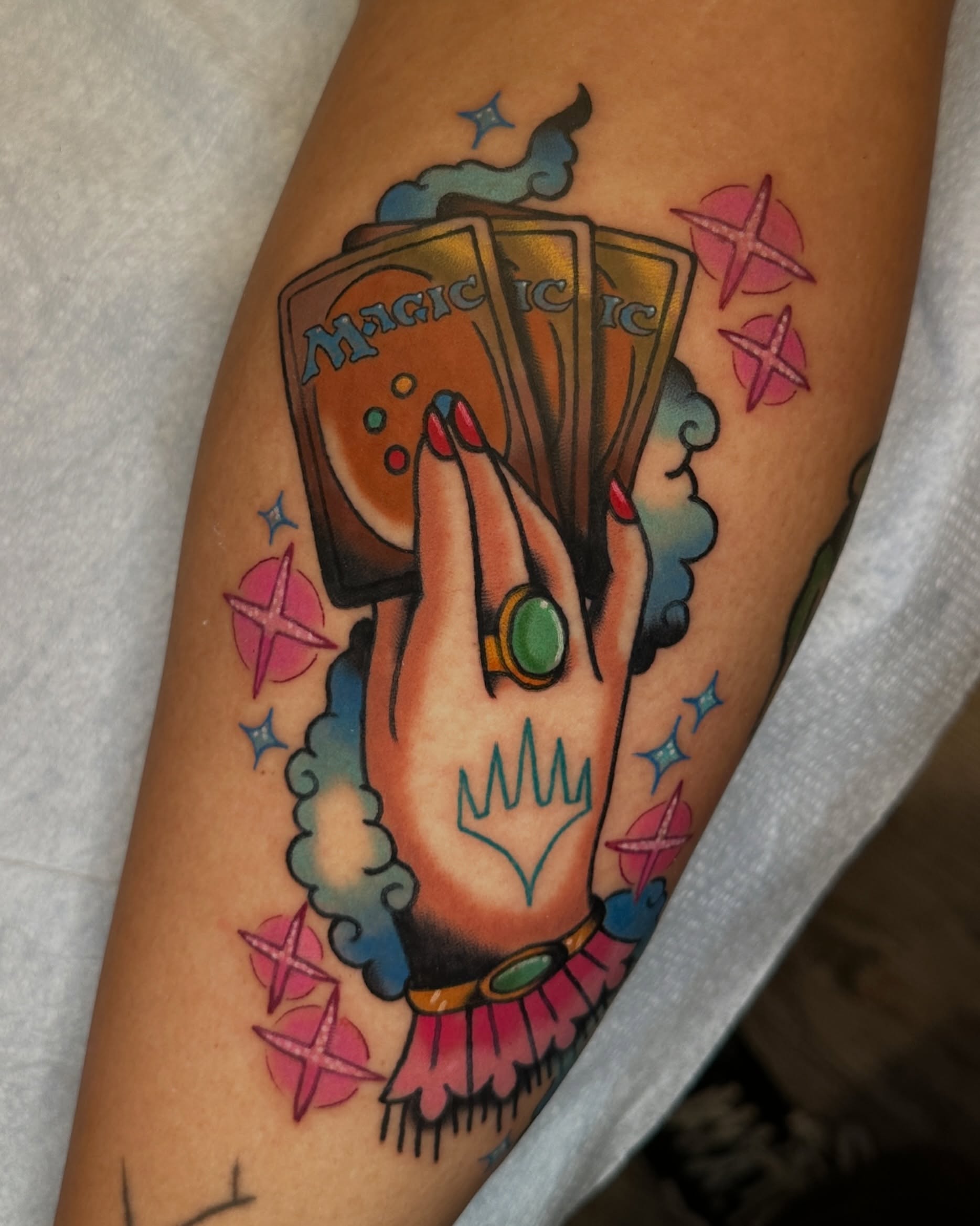 Hand with cards American traditional tattoo on the forearm by Paige Ochoa