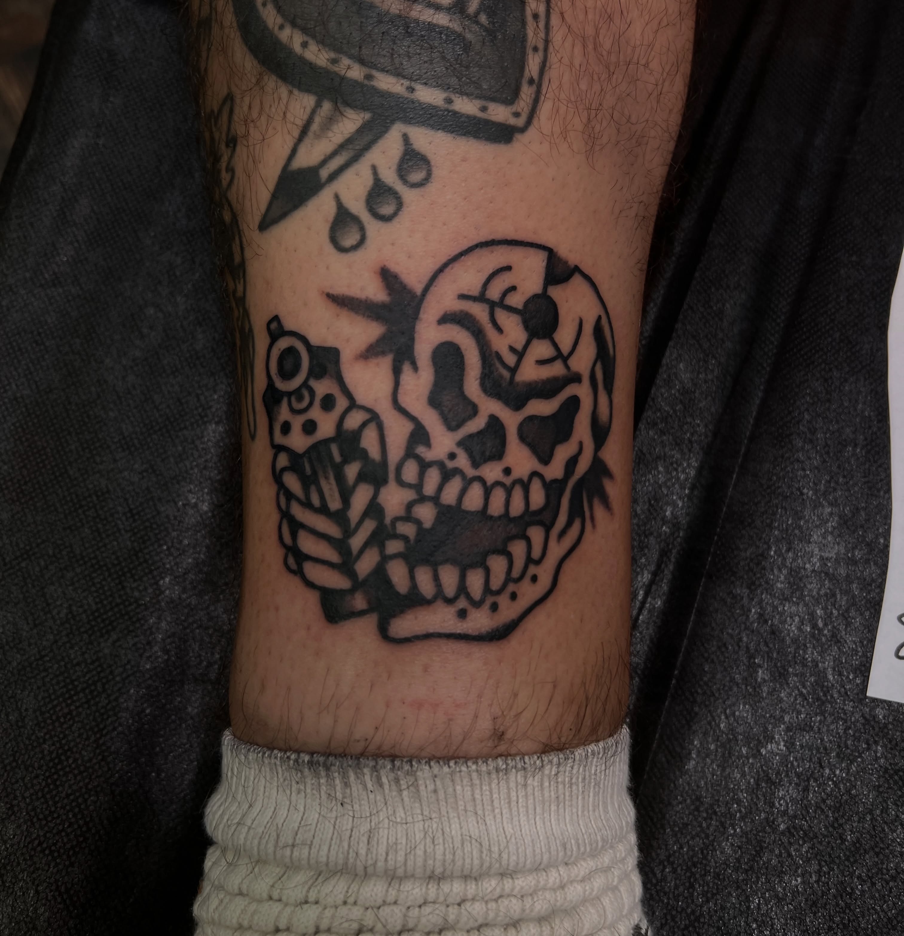 Skull with gun black and grey tattoo on the forearm by 🍊Harvey Perez 🍊, Deerfield Beach, Florida