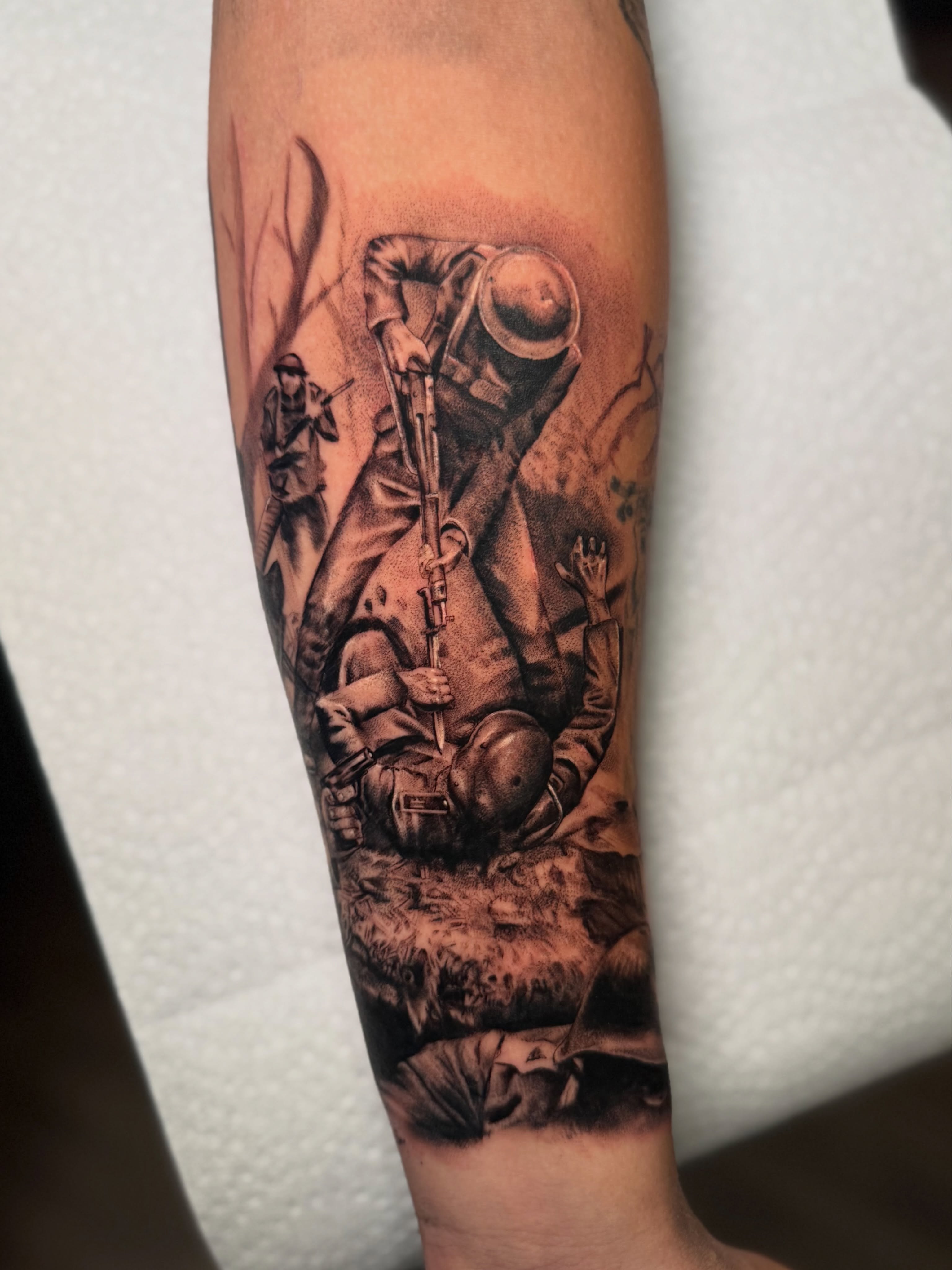 Soldiers in combat realism tattoo on the forearm by Tatum