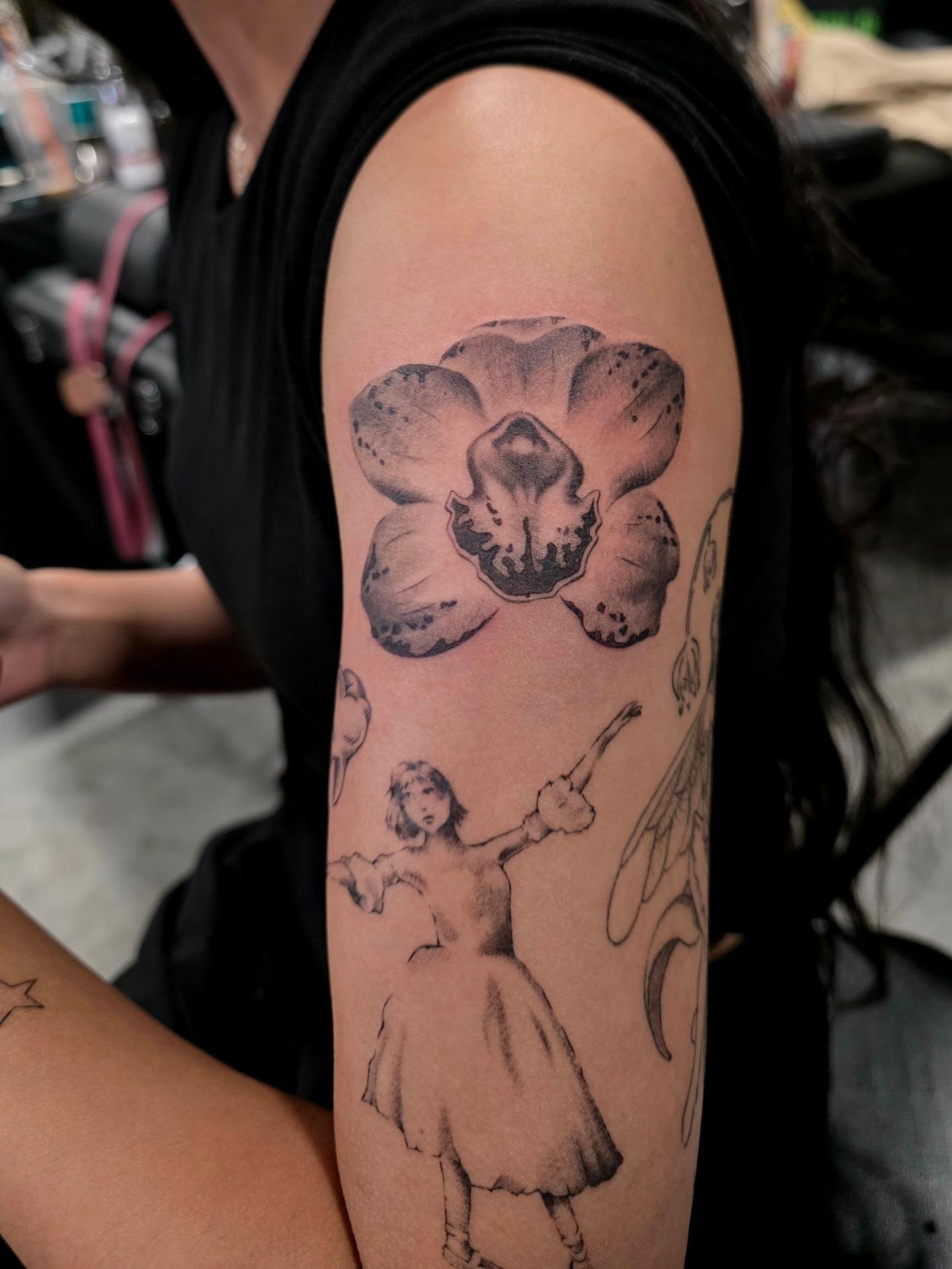 Orchid and girl realism tattoo on the forearm by Ashley Johnson, Knoxville, Tennessee