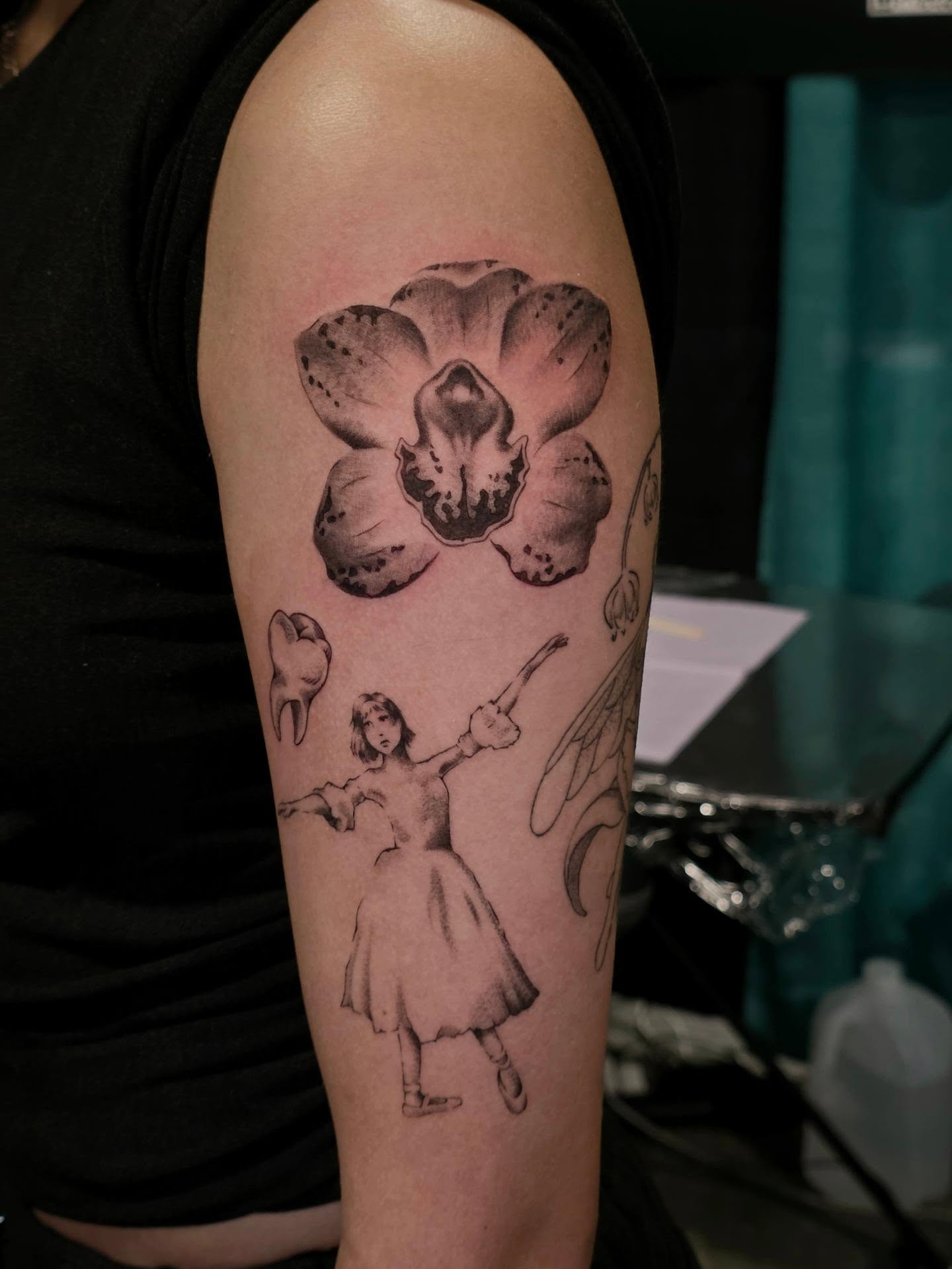 Orchid and girl black and grey tattoo on the forearm by Ashley Johnson, Knoxville, Tennessee