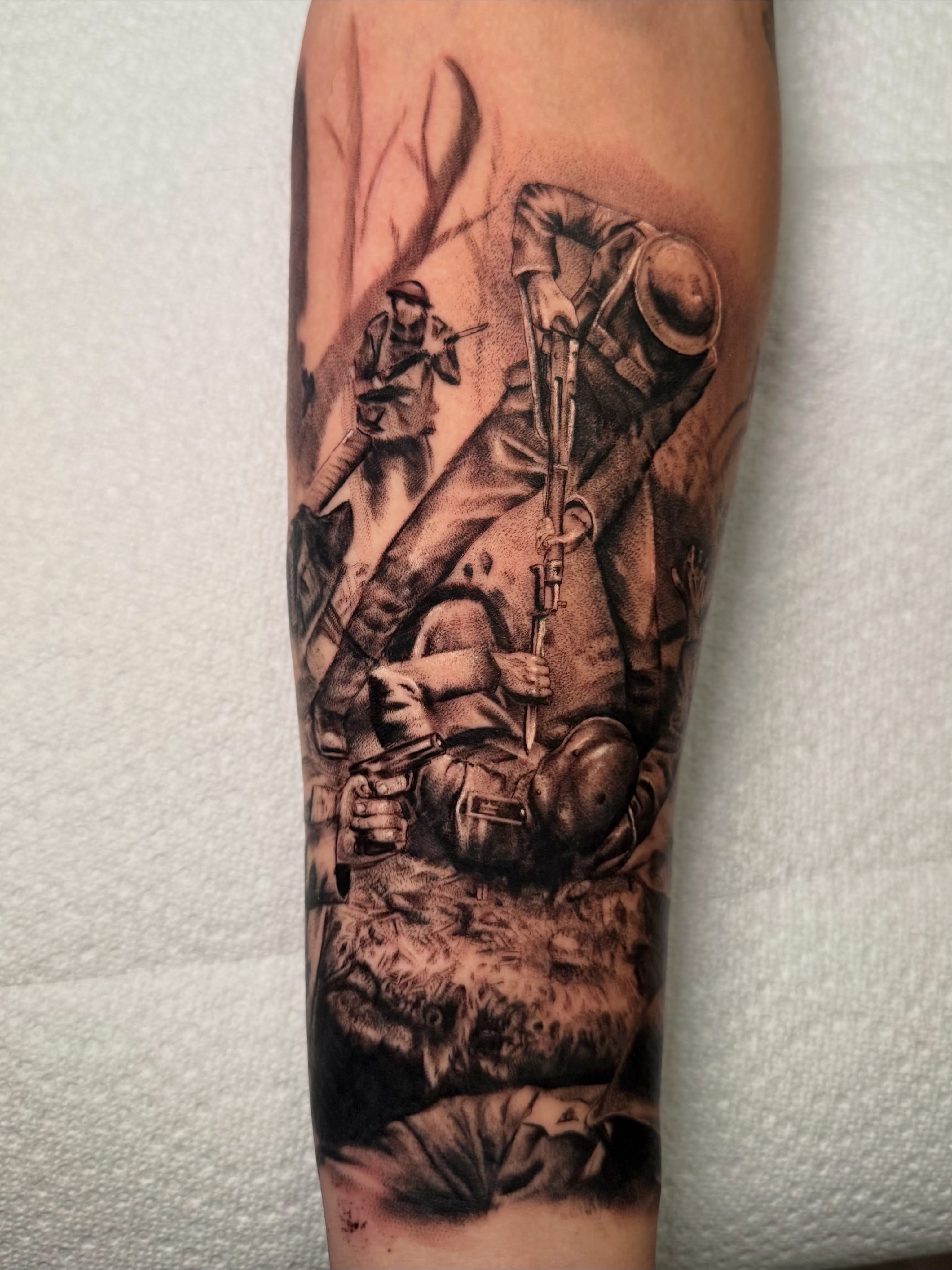 Soldiers in battle realism tattoo on the forearm by Tatum