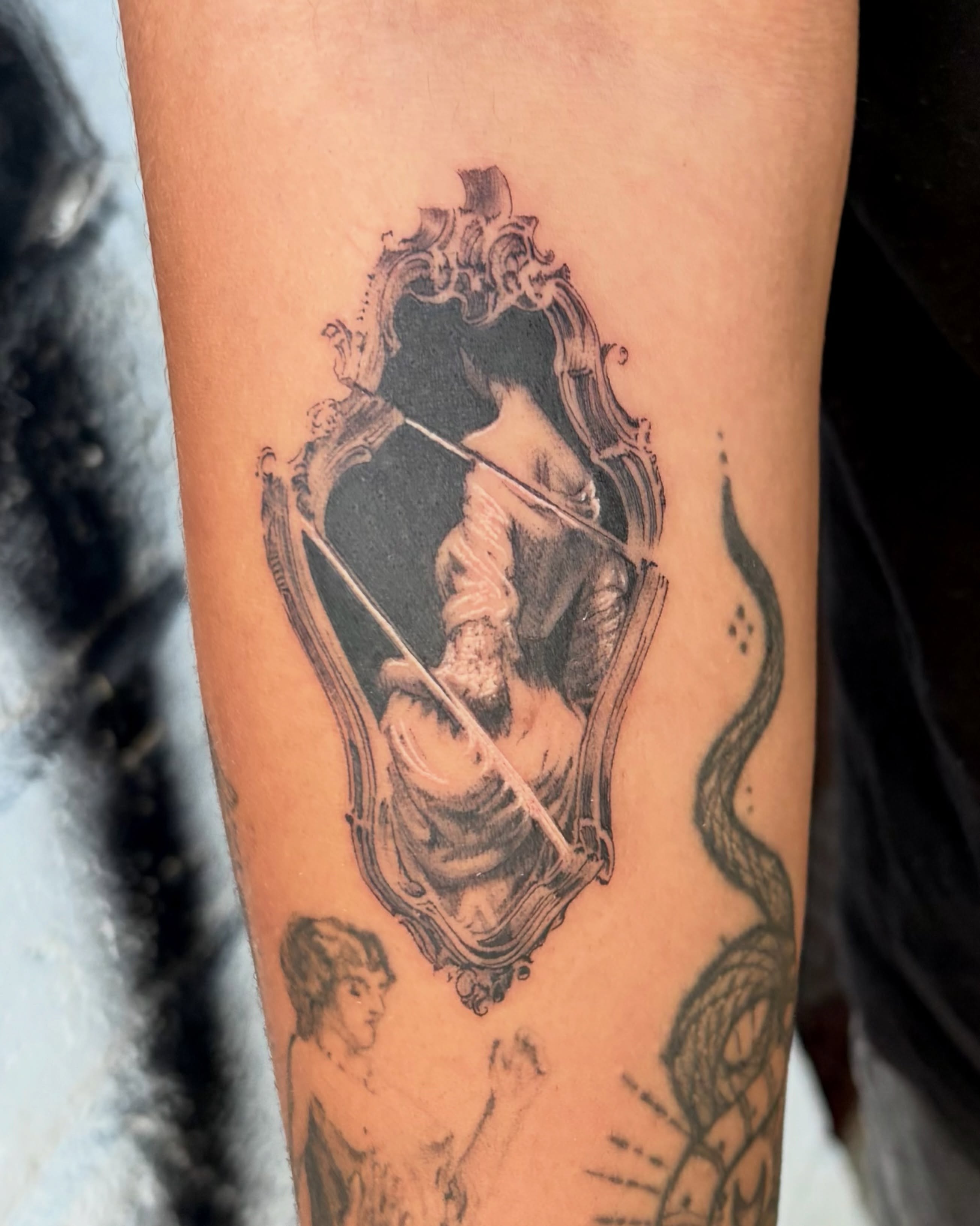 Mirror reflection realism tattoo on the forearm by Kylah Amin Tattoo