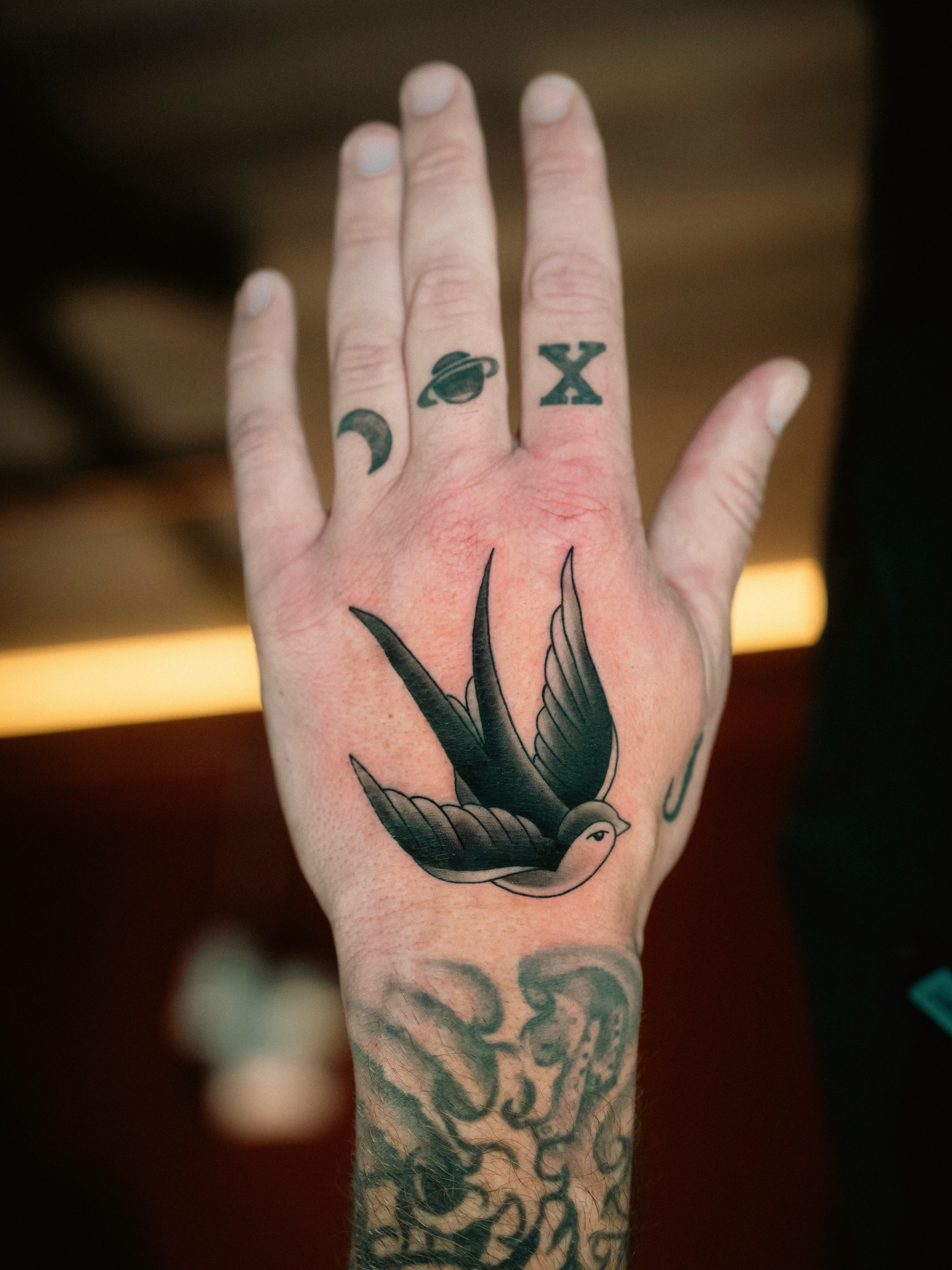 Swallow bird American traditional tattoo on the hand by Franz Muñoz