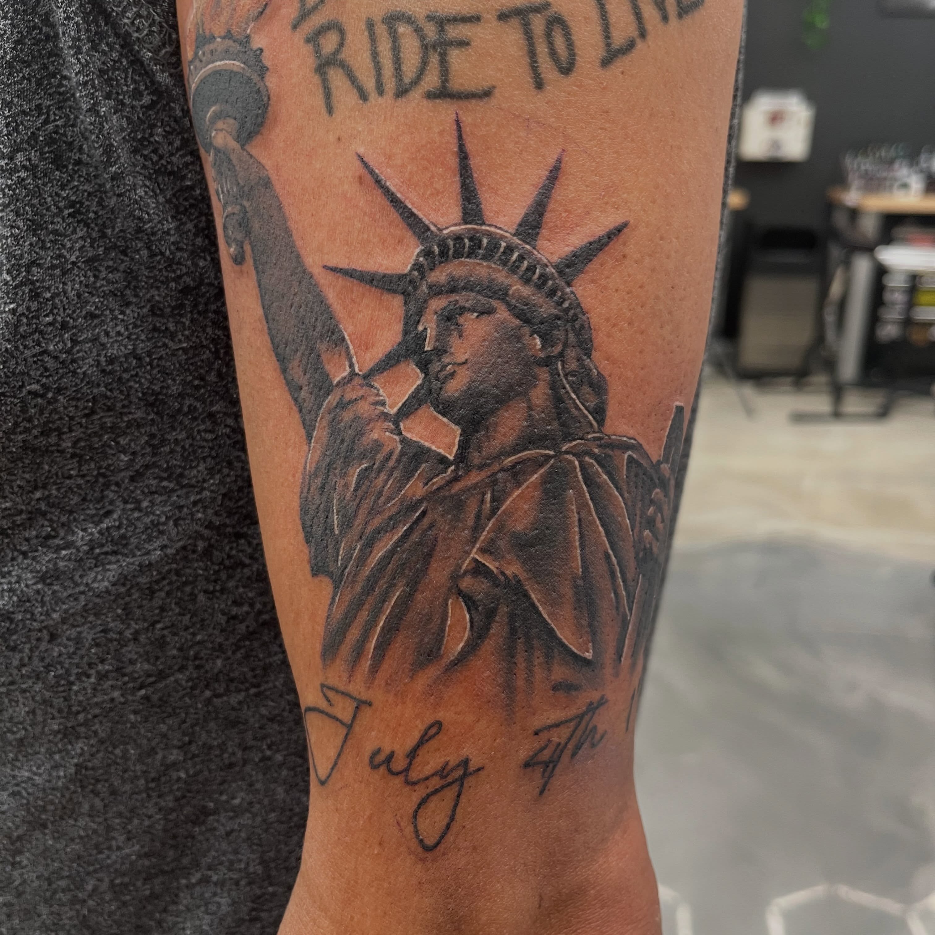 Statue of liberty black and grey tattoo on the forearm by Tyler Howard