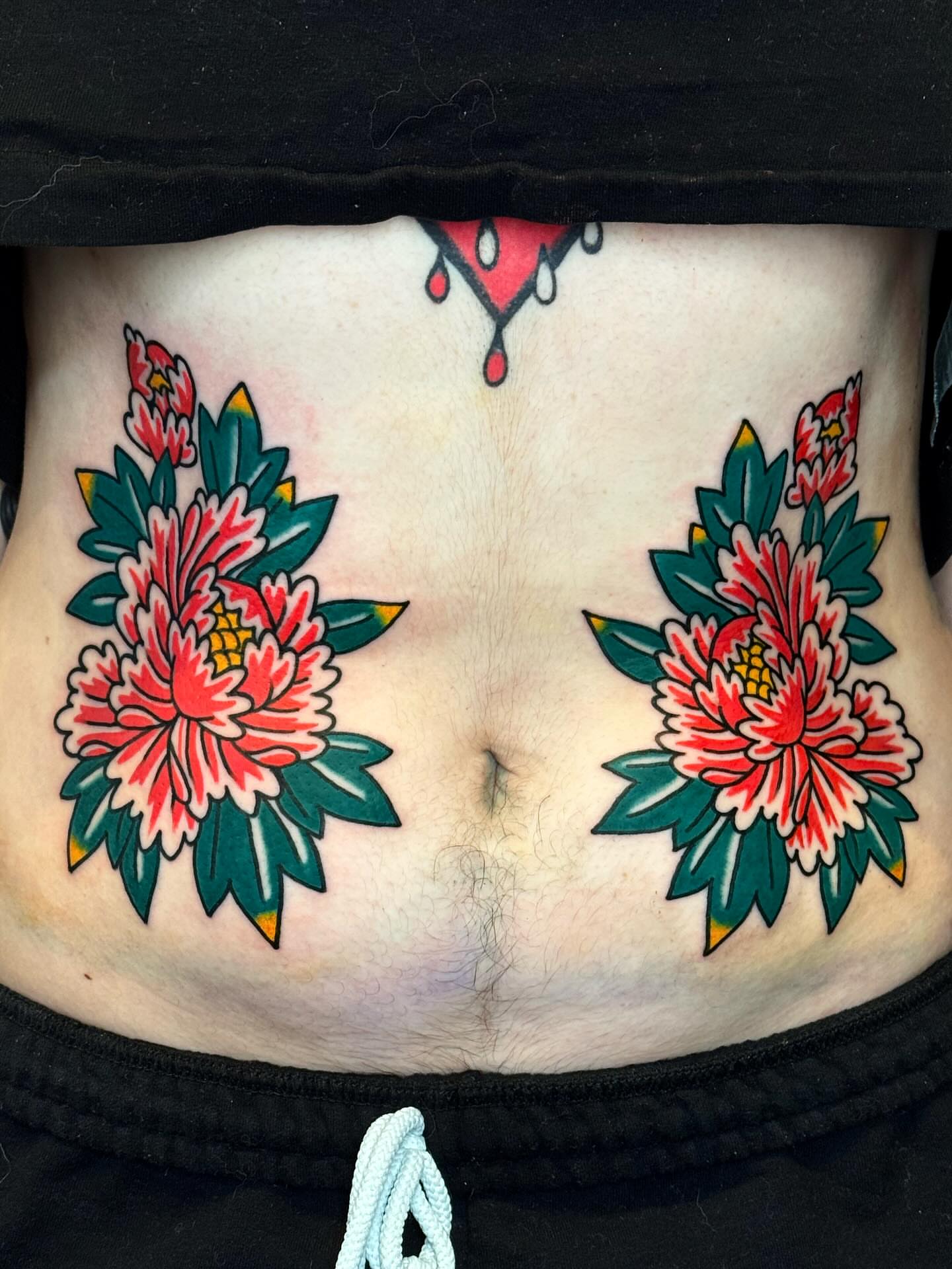 Chrysanthemums American traditional tattoo on the torso by Bryce Shearer