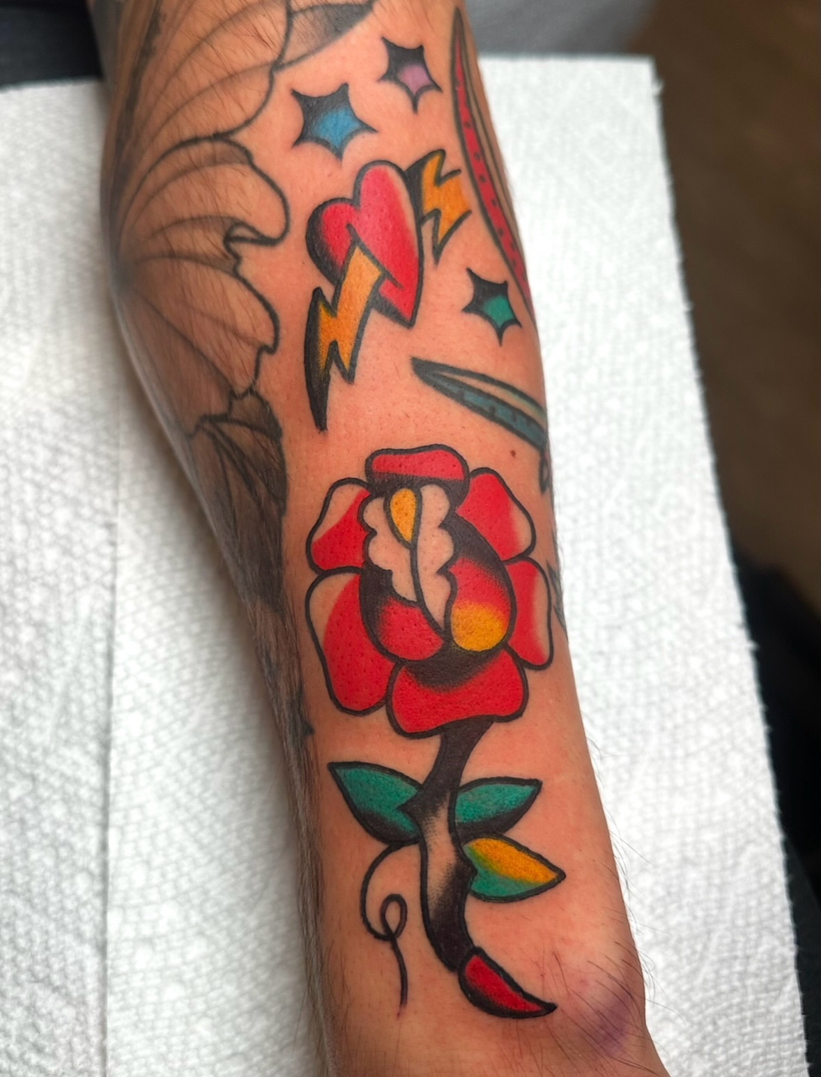 Flower American traditional tattoo on the forearm by Zahra Niedermann