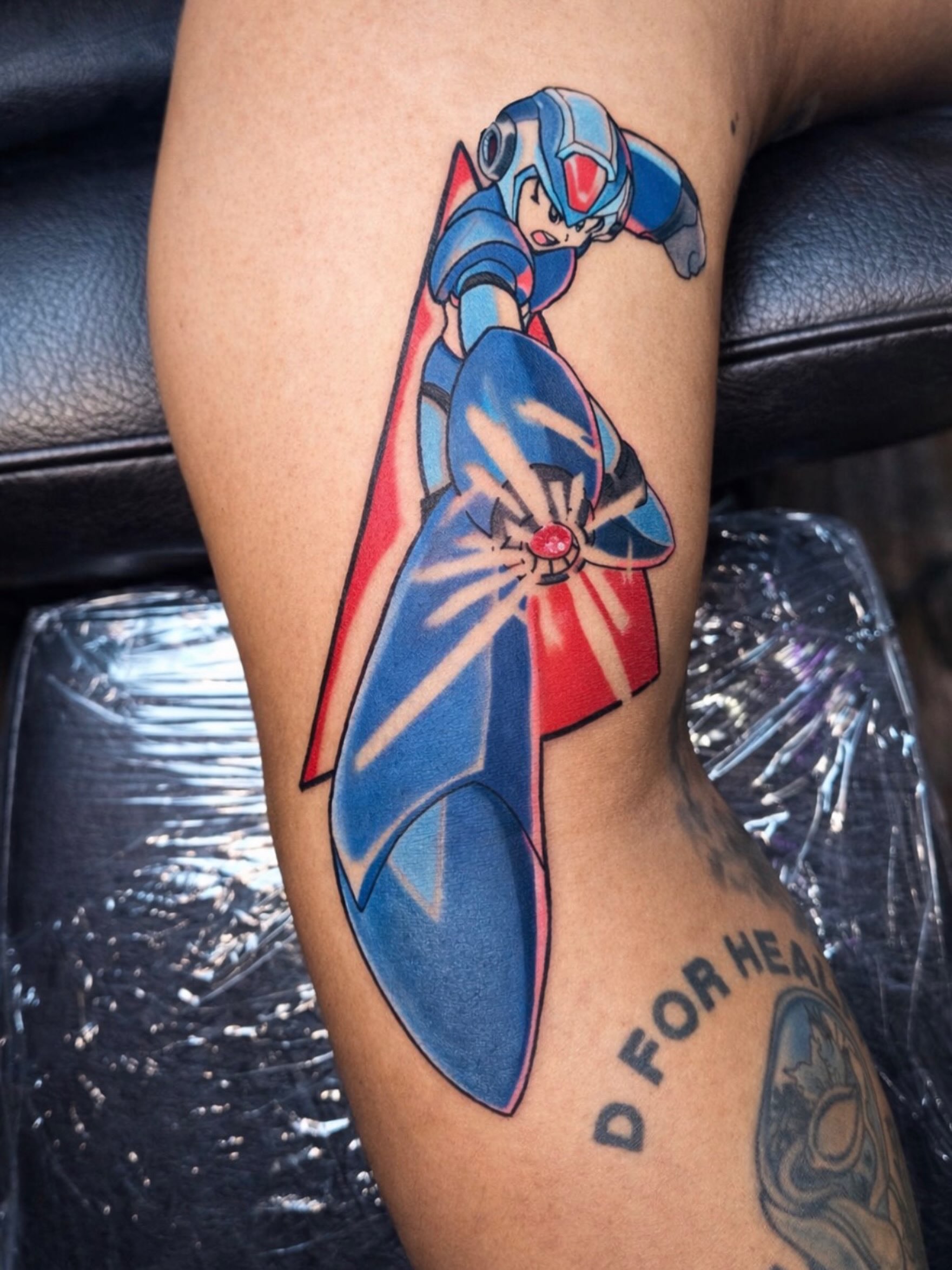 Megaman anime tattoo on the thigh by Kelsoink