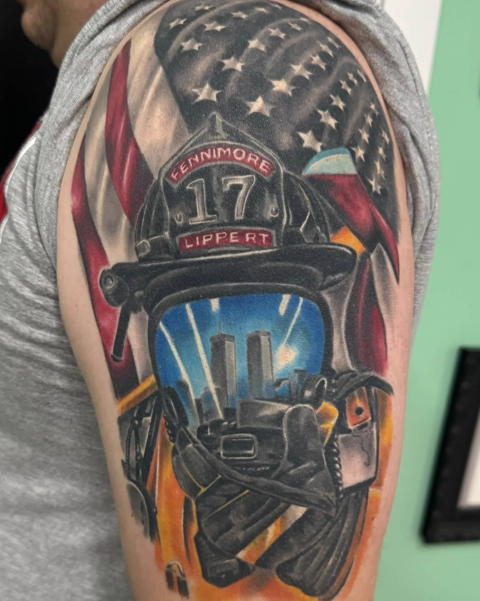 Firefighter helmet realism tattoo on the upper arm by Skott Kautman, Dubuque, Iowa