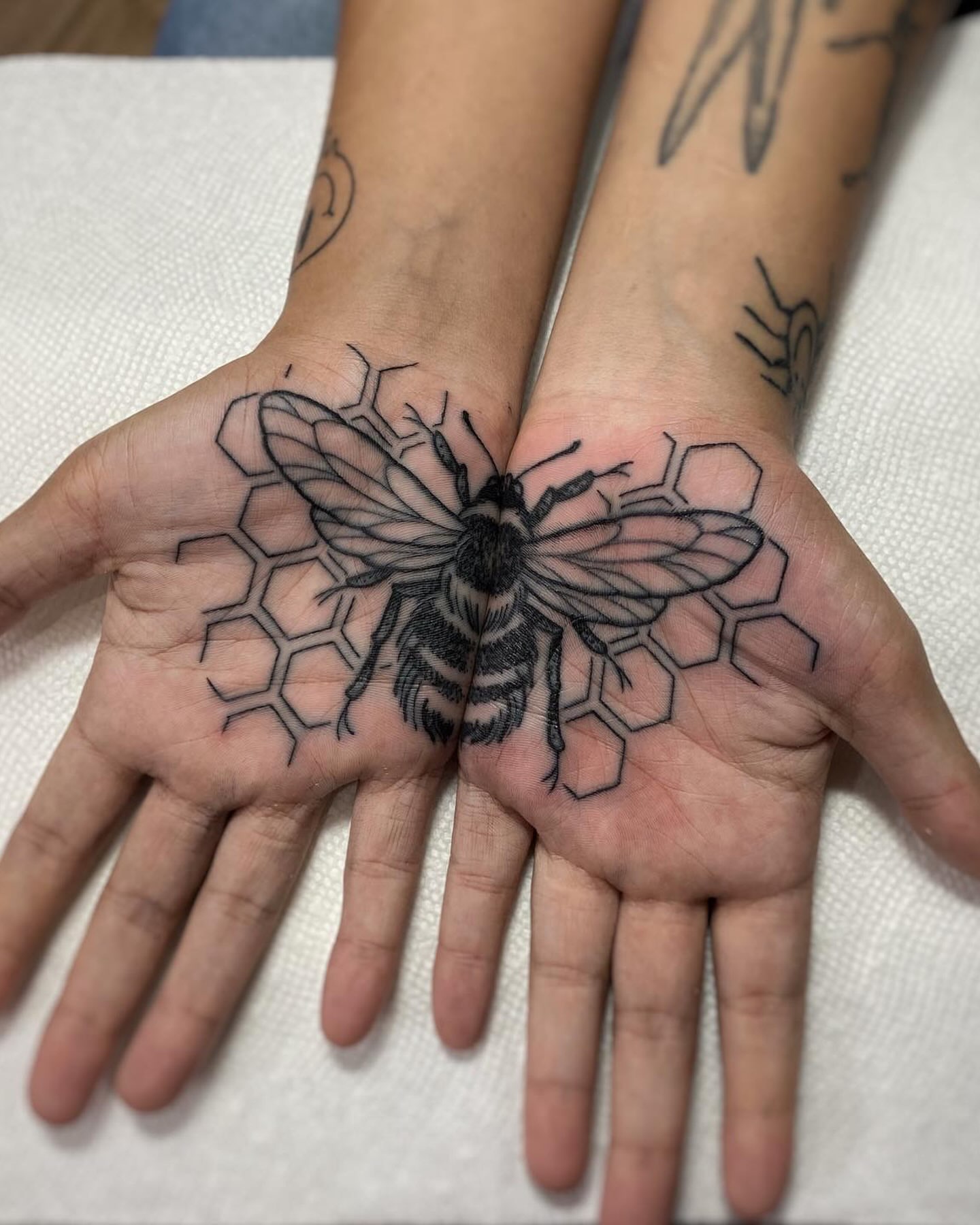 Bee black and grey tattoo on the hand by Mark Walker