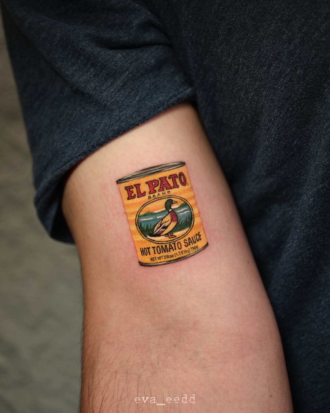 El pato hot tomato sauce can American traditional tattoo on the forearm by Eva Liu