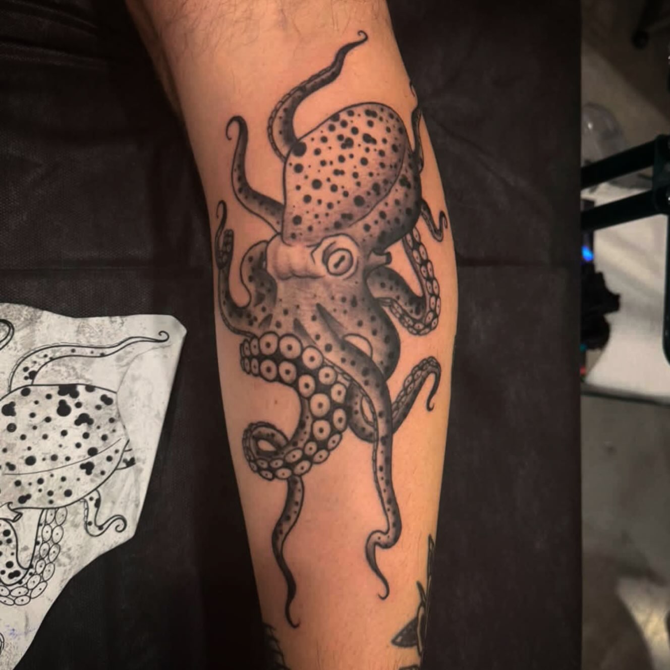 Octopus black and grey tattoo on the forearm by Brett Ferguson