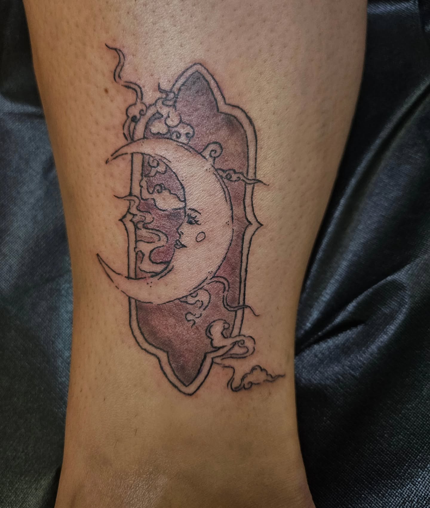 Moon and face black and grey tattoo on the forearm by ݁˖