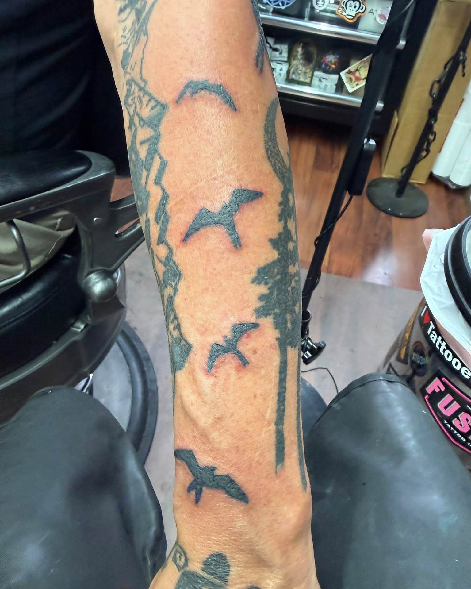 Birds black and grey tattoo on the forearm by @lady_raven_tattoo