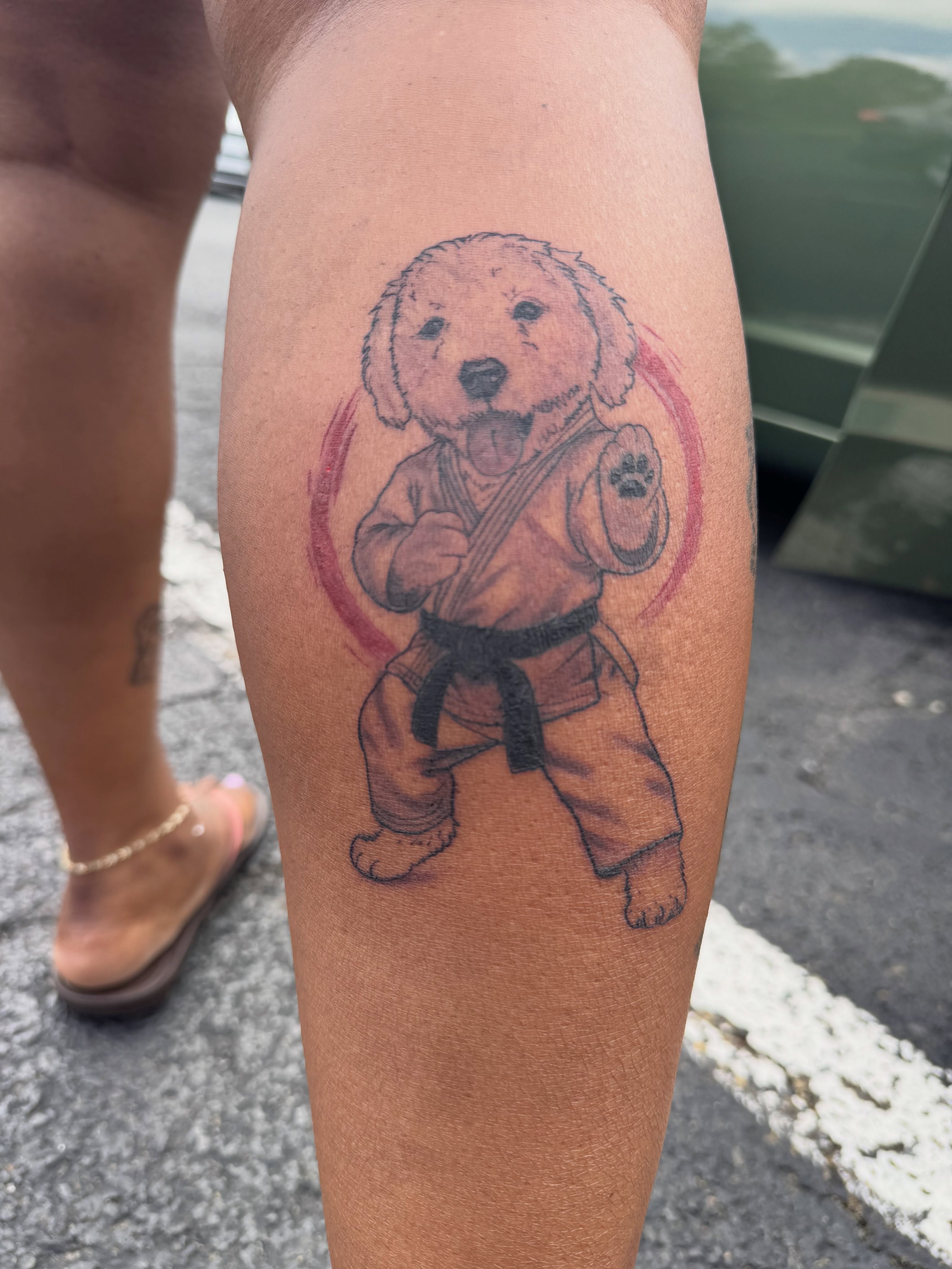 Dog in karate pose realism tattoo on the thigh by Tattoos by Fesik LLC