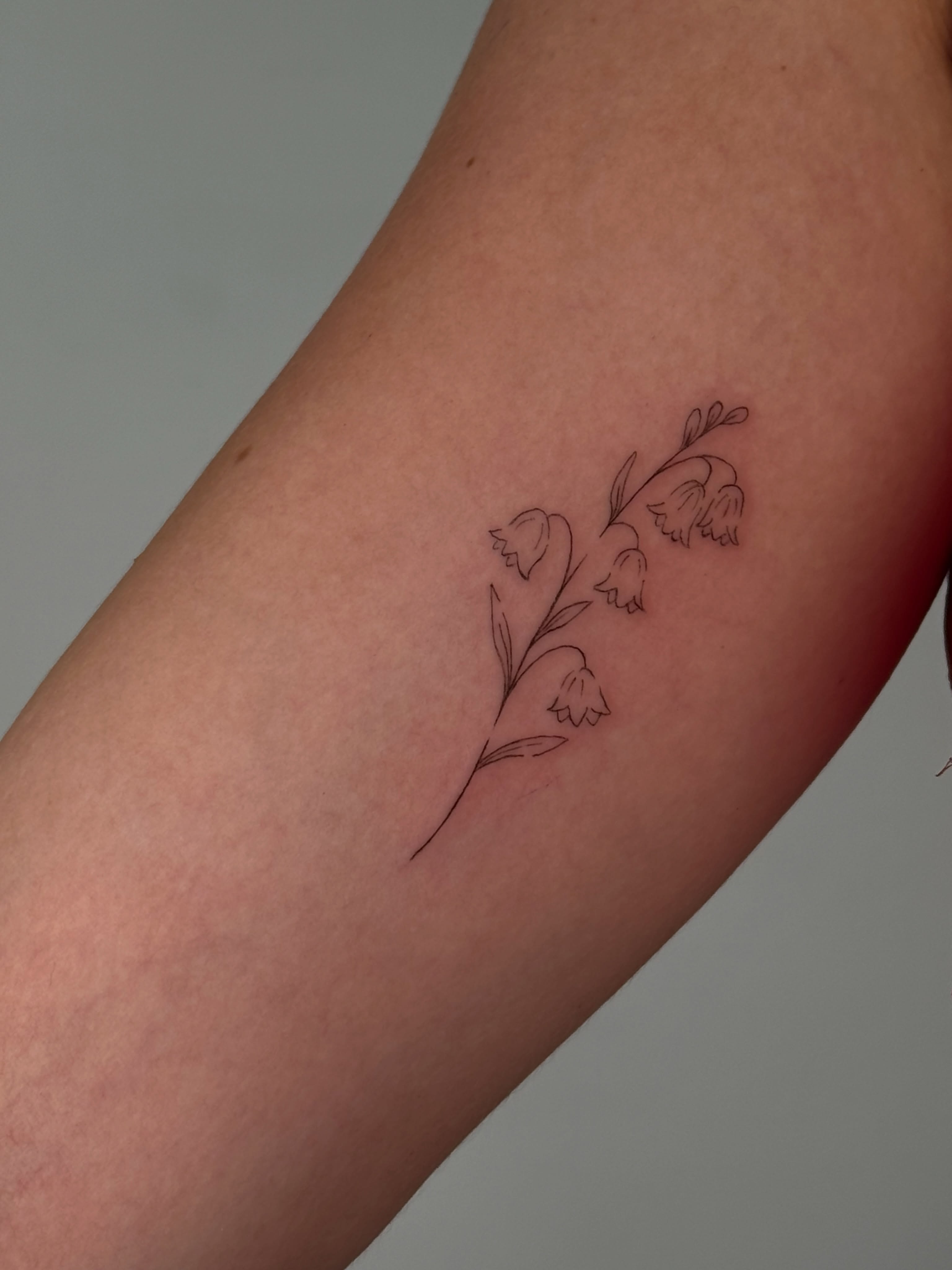 Snowbell flowers fine line tattoo on the forearm by Jules Ink ⋆ Fineline Tattoo