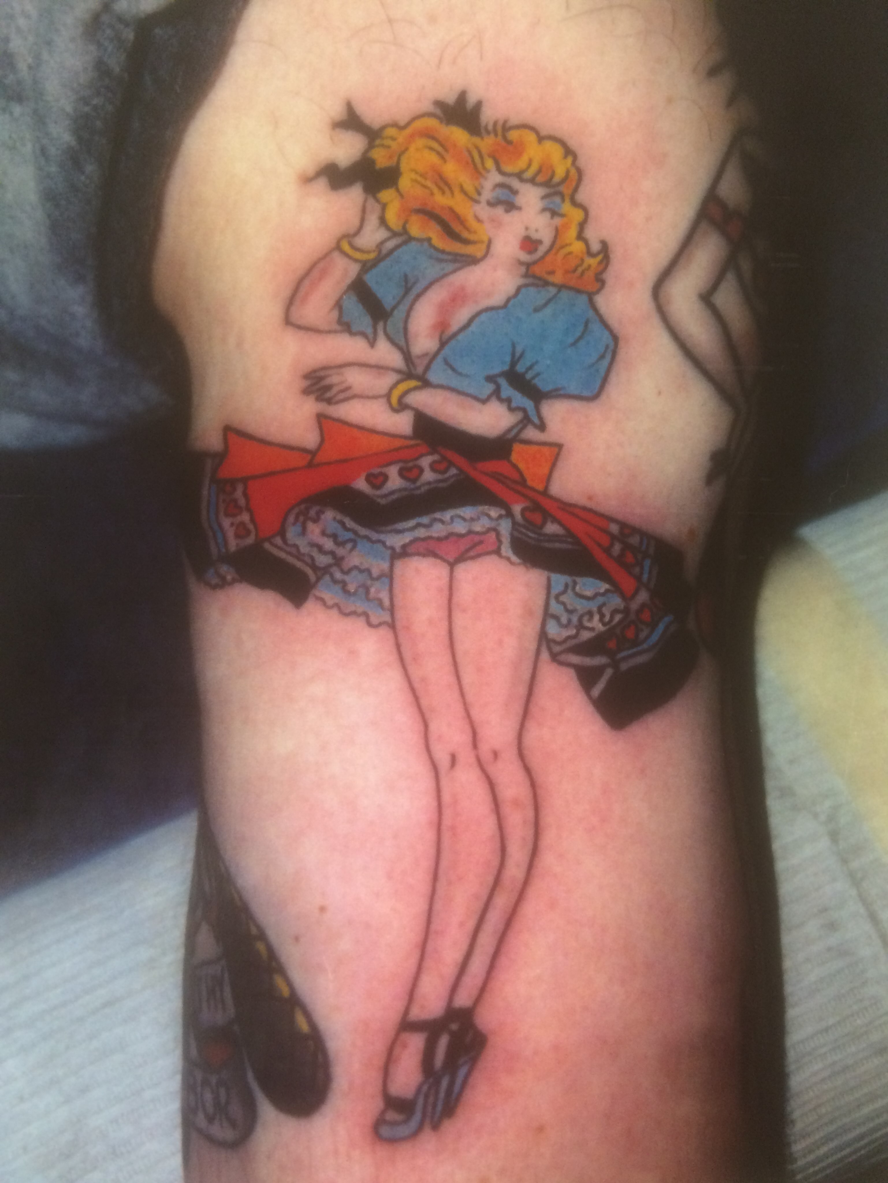 Pin-up girl American traditional tattoo on the forearm by El Kapitan