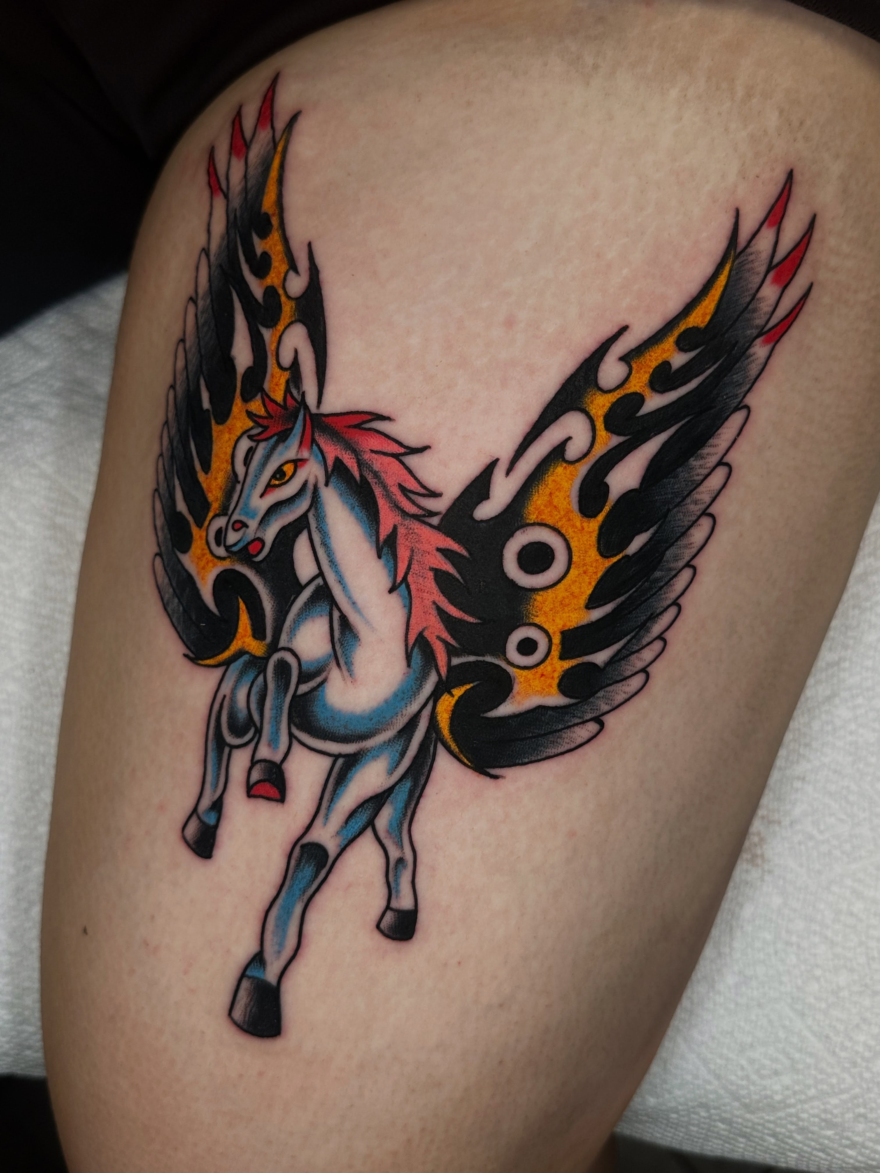 Winged unicorn American traditional tattoo on the thigh by Spencer Crawford, Speedway, Indiana