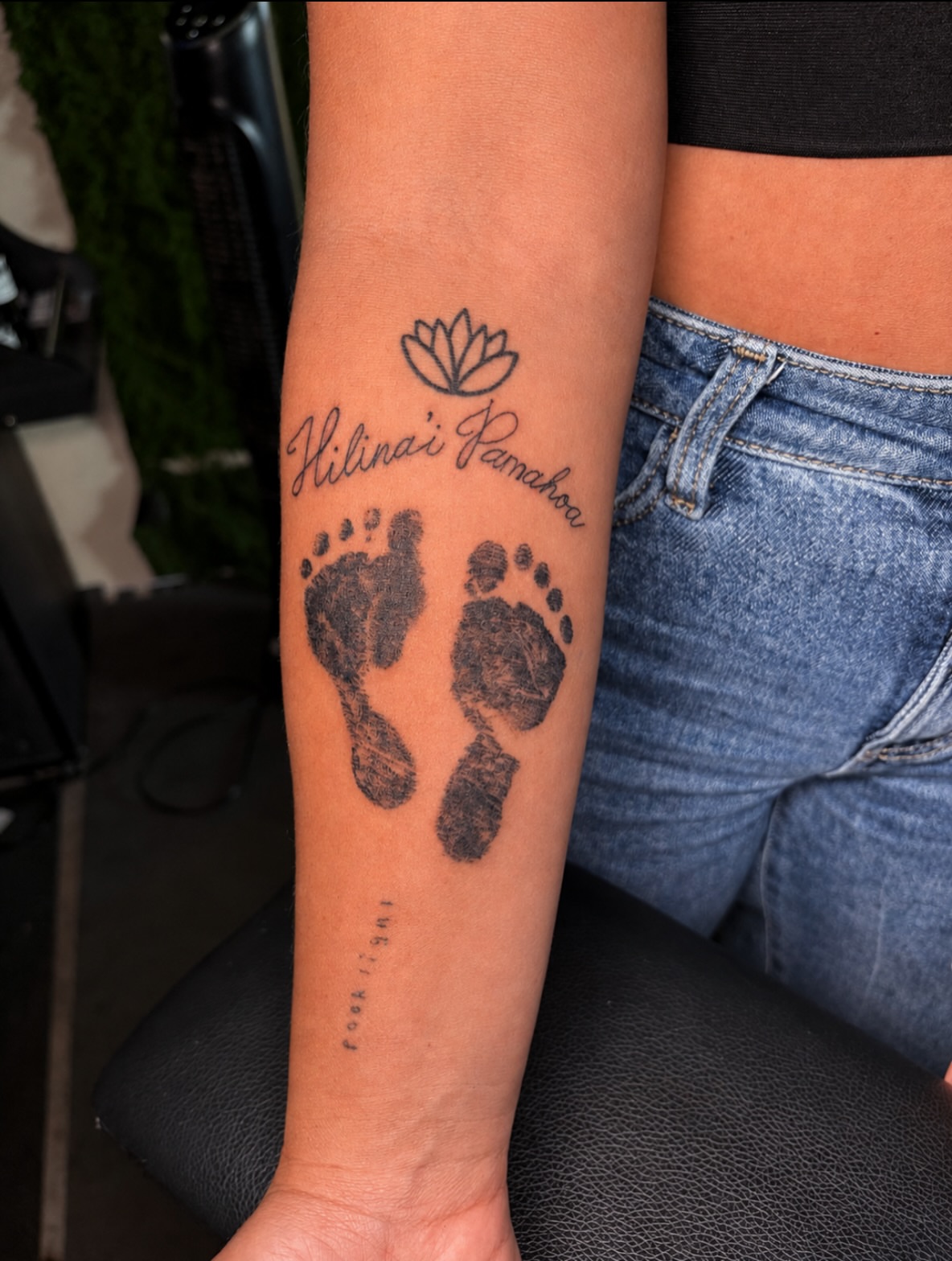 Footprints and lotus black and grey tattoo on the forearm by Cece, Las Vegas, Nevada
