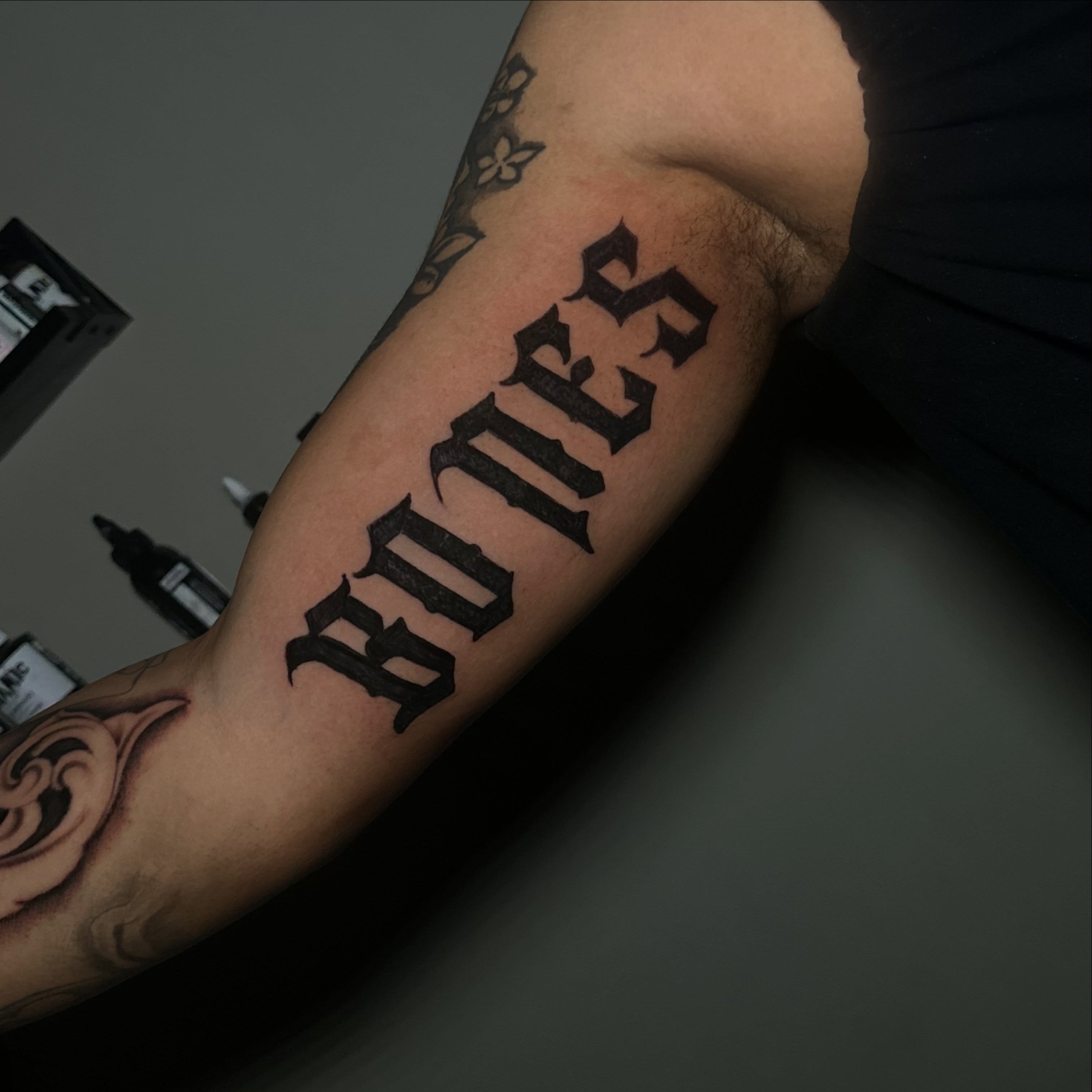 Bones lettering script tattoo on the forearm by @tattedbytuck