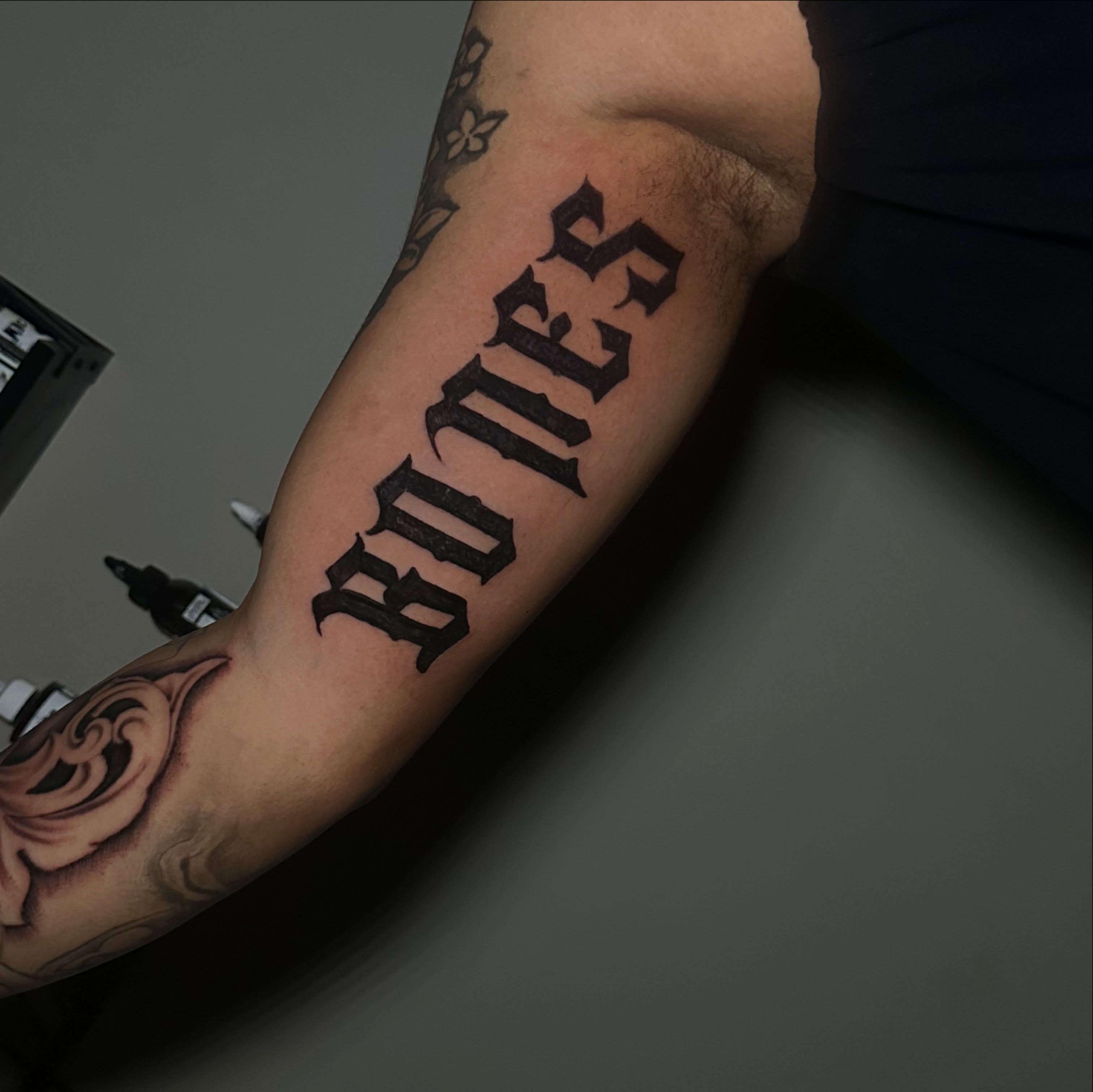 Bones lettering script tattoo on the forearm by @tattedbytuck
