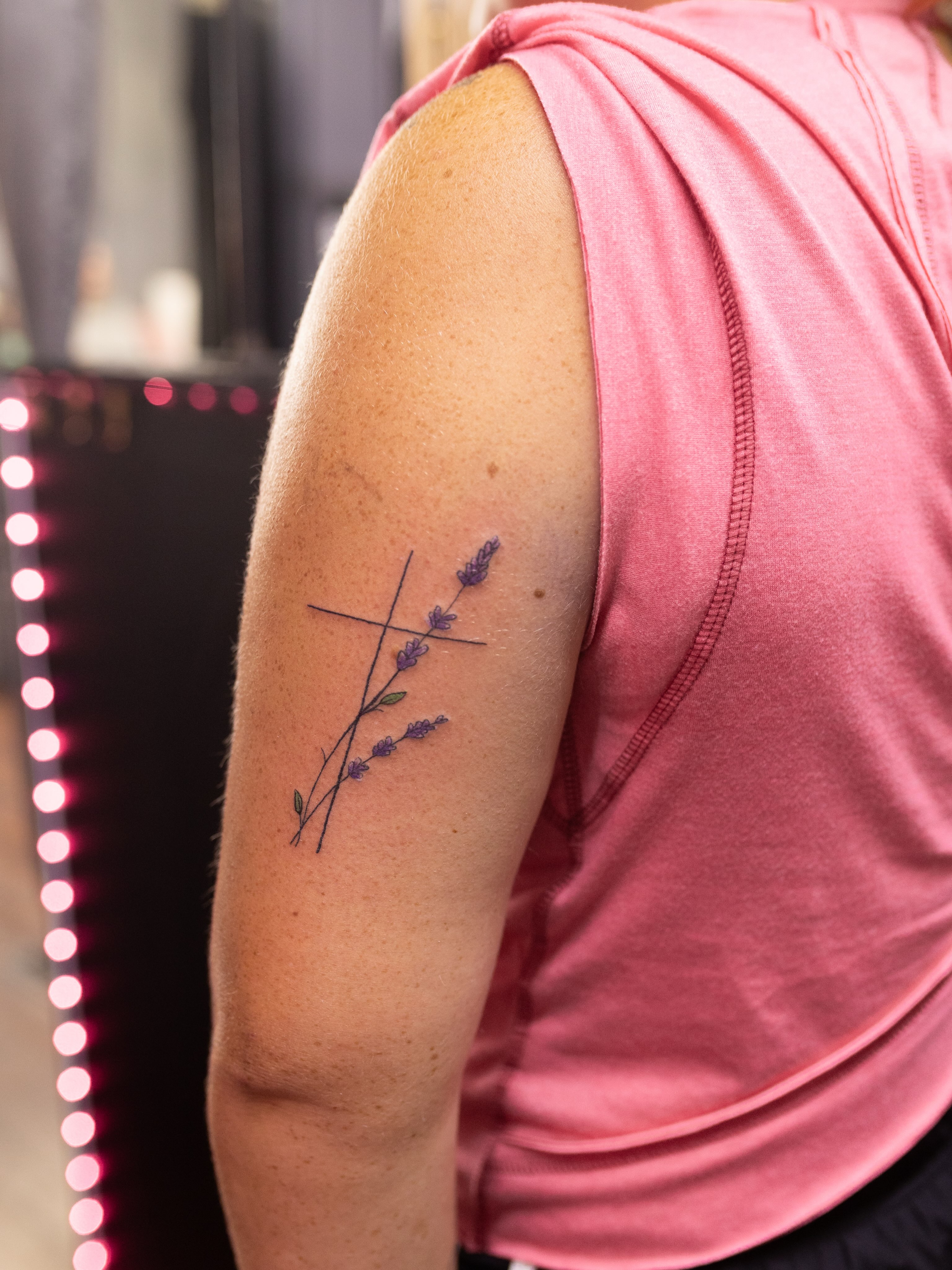 Lavender branch fine line tattoo on the shoulder by Kelsie