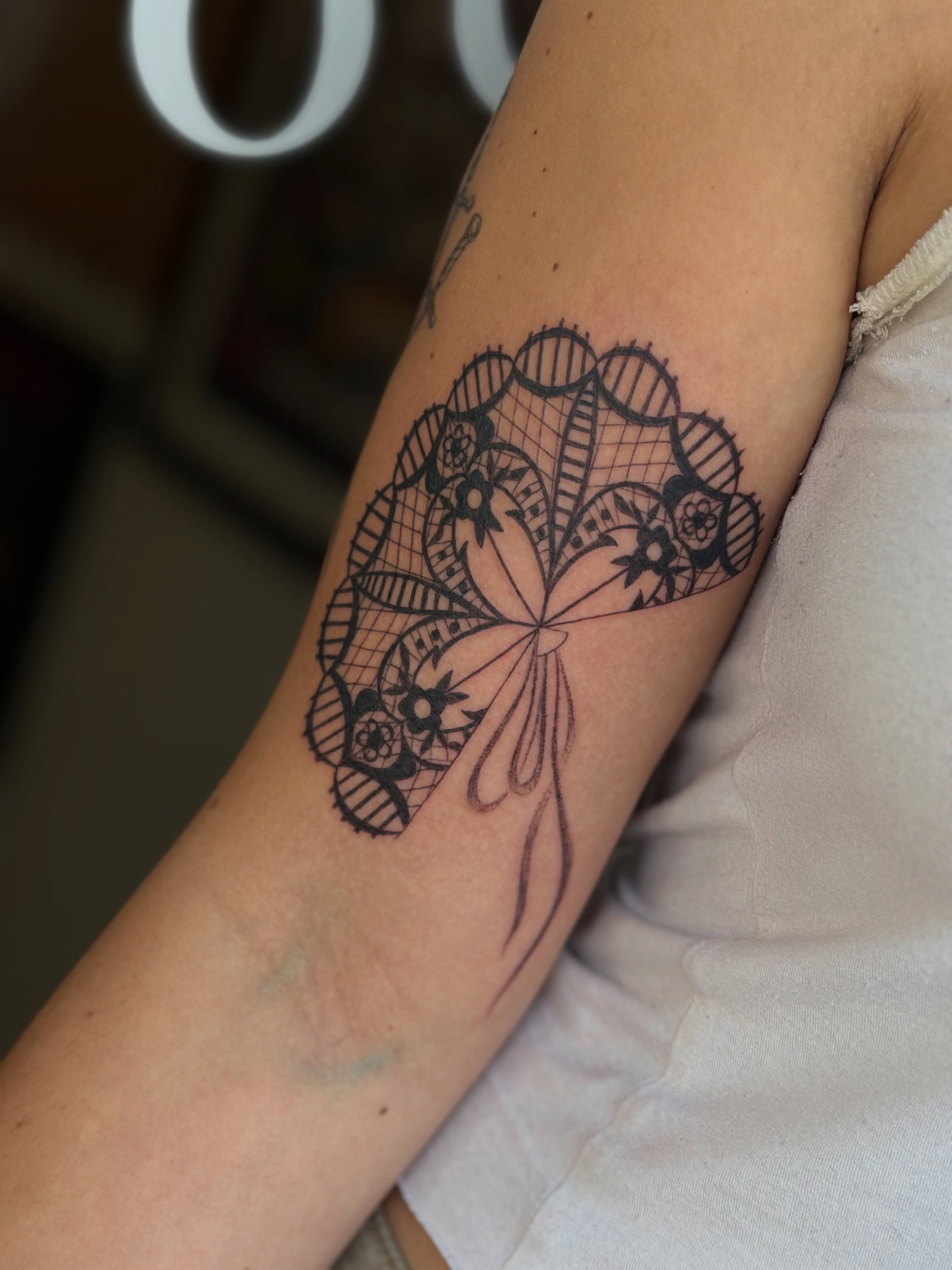 Lace fan black and grey tattoo on the forearm by Maddie Blosser, Portland, Oregon