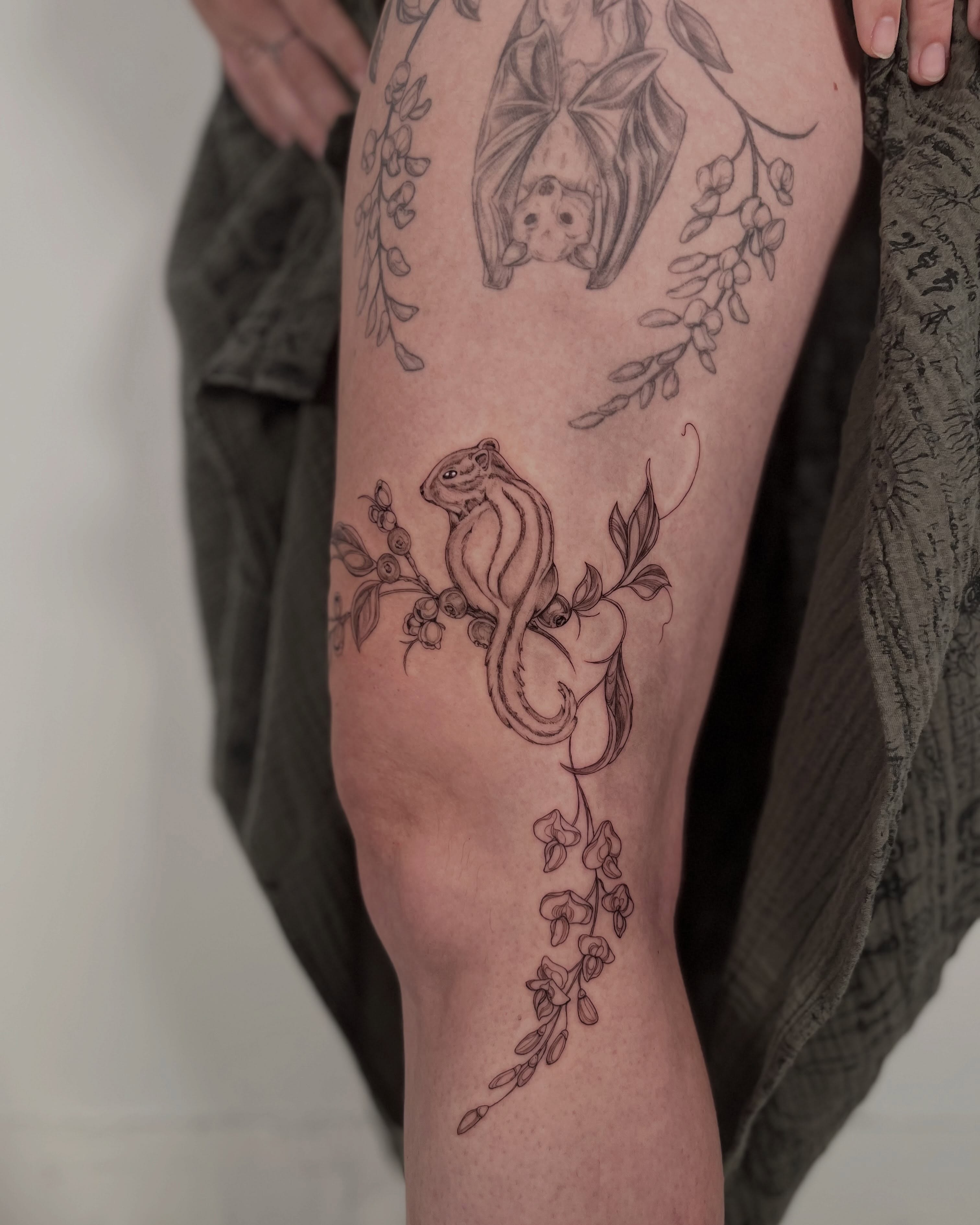 Bat and squirrel realism tattoo on the thigh by Sierra Skye