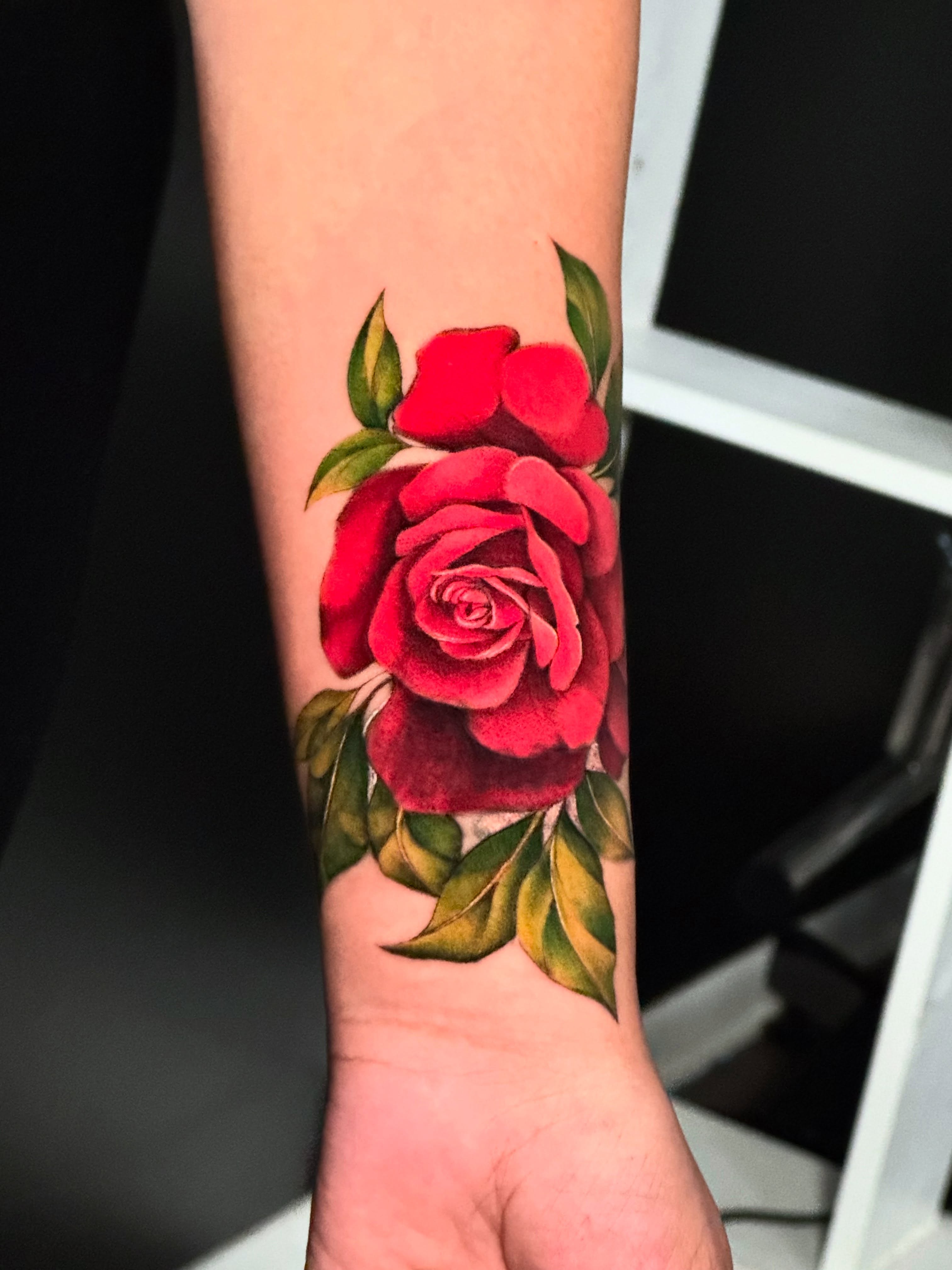 Red rose realism tattoo on the forearm by HAiZiE