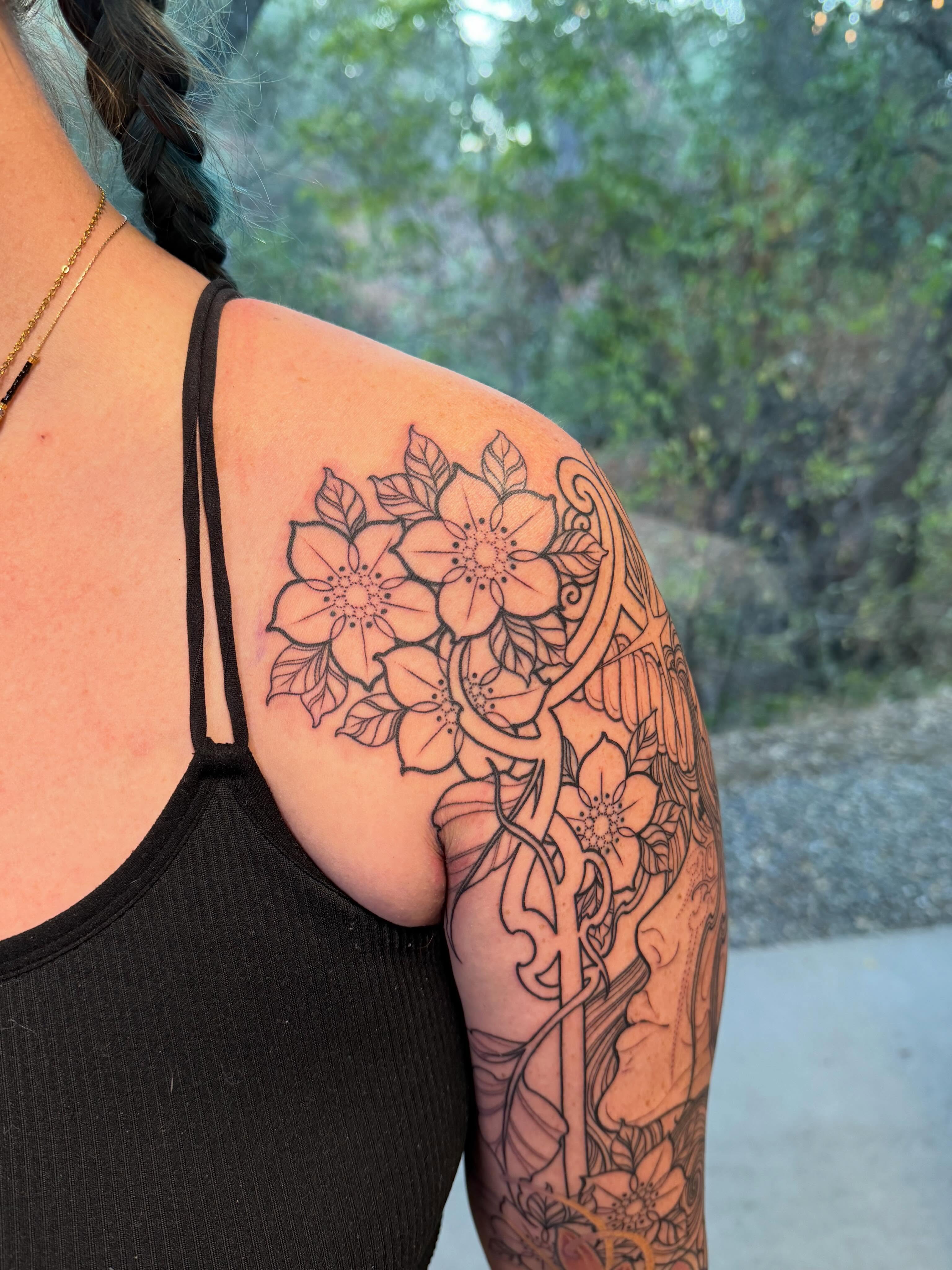 Flower bouquet black and grey tattoo on the shoulder by <