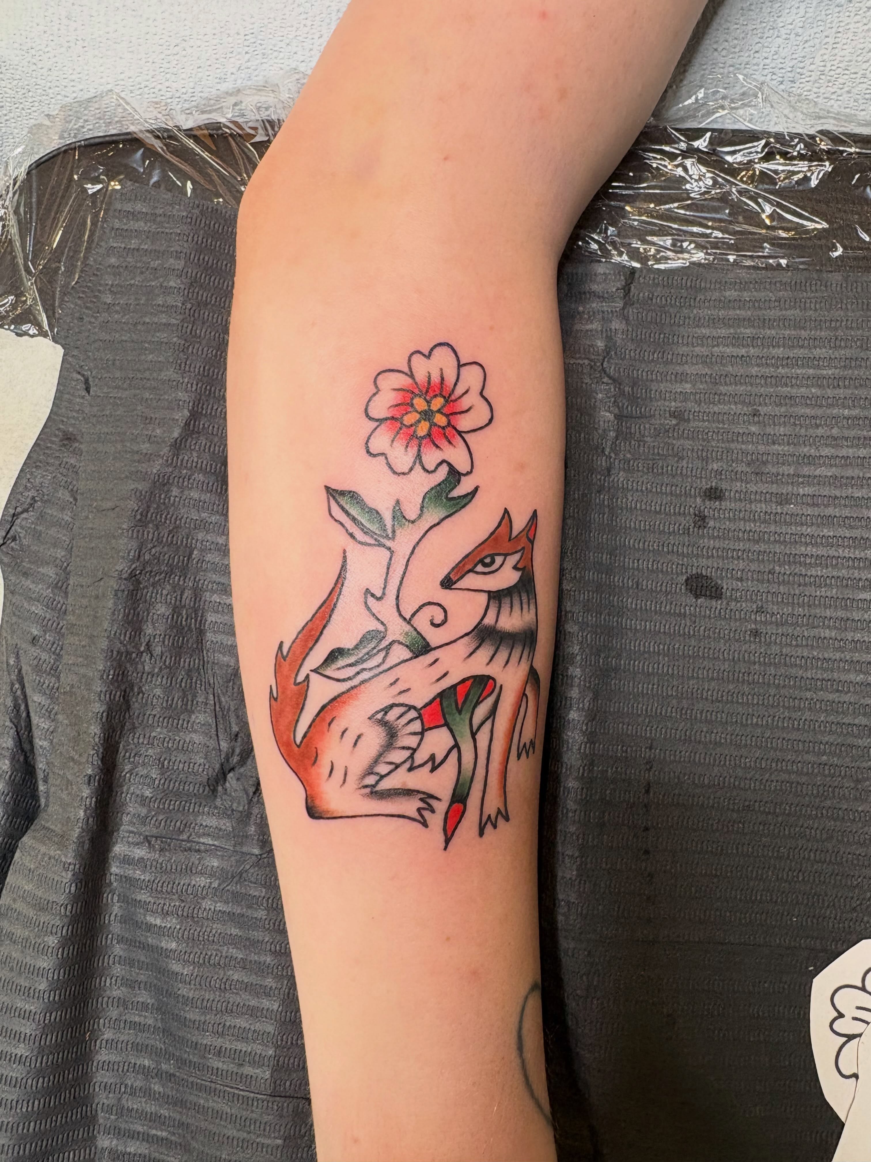 Fox and flower American traditional tattoo on the forearm by ellie