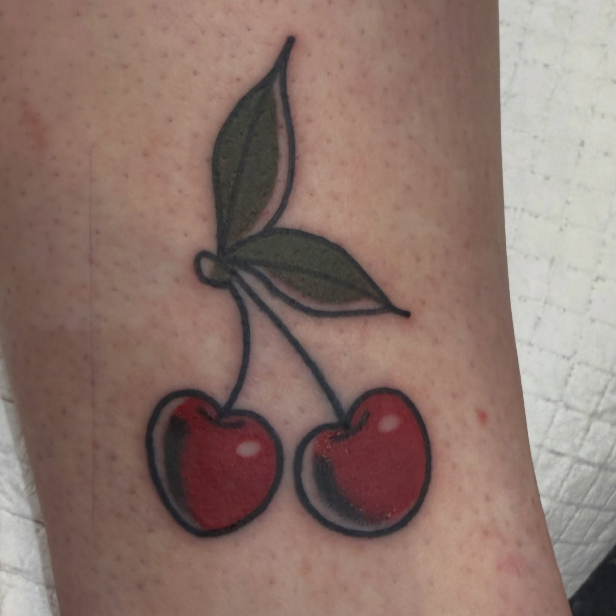 Cherries realism tattoo on the forearm by Chris Smiseck