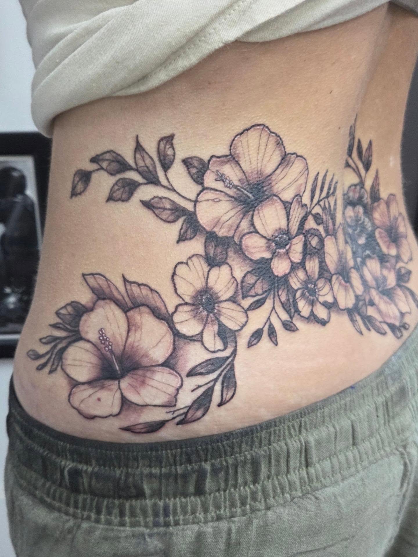 Floral bouquet black and grey tattoo on the ribs by Matthew Todd Kremer