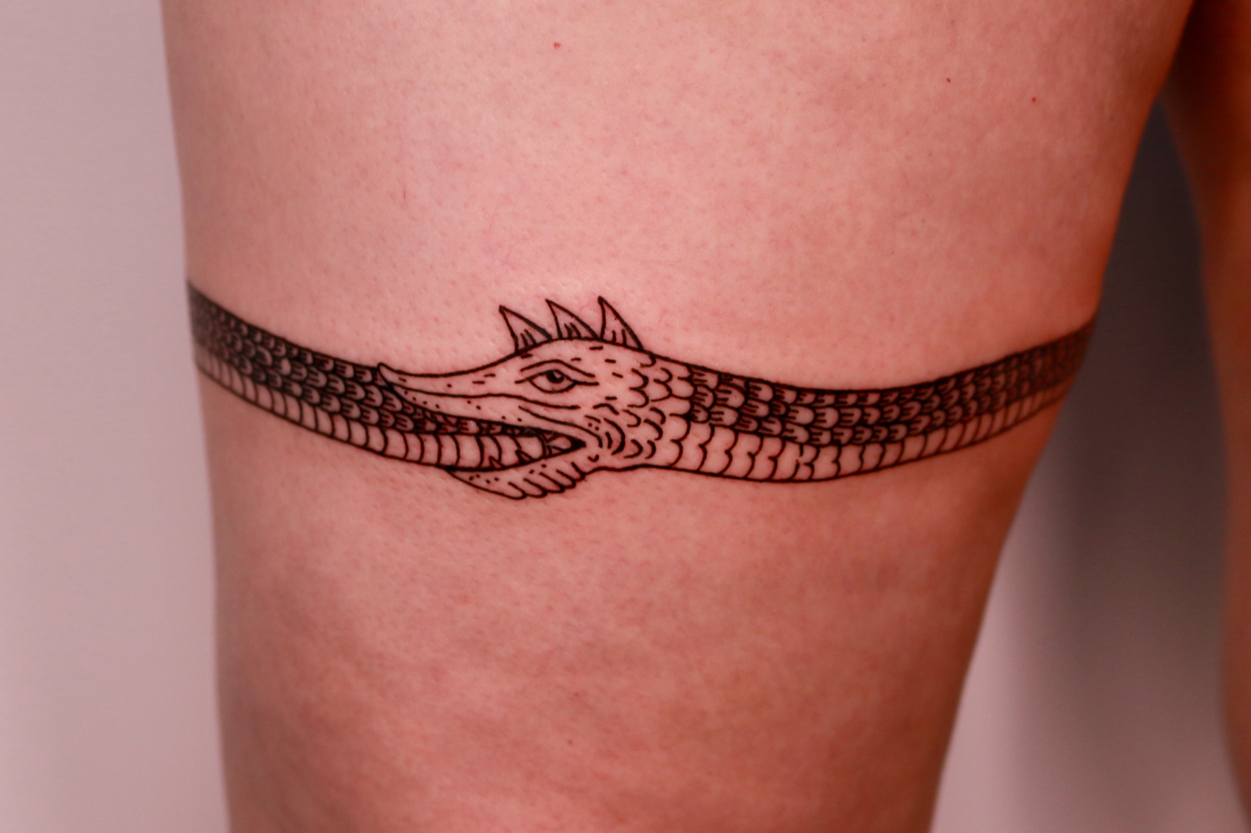 Alligator black and grey tattoo on the thigh by Mike