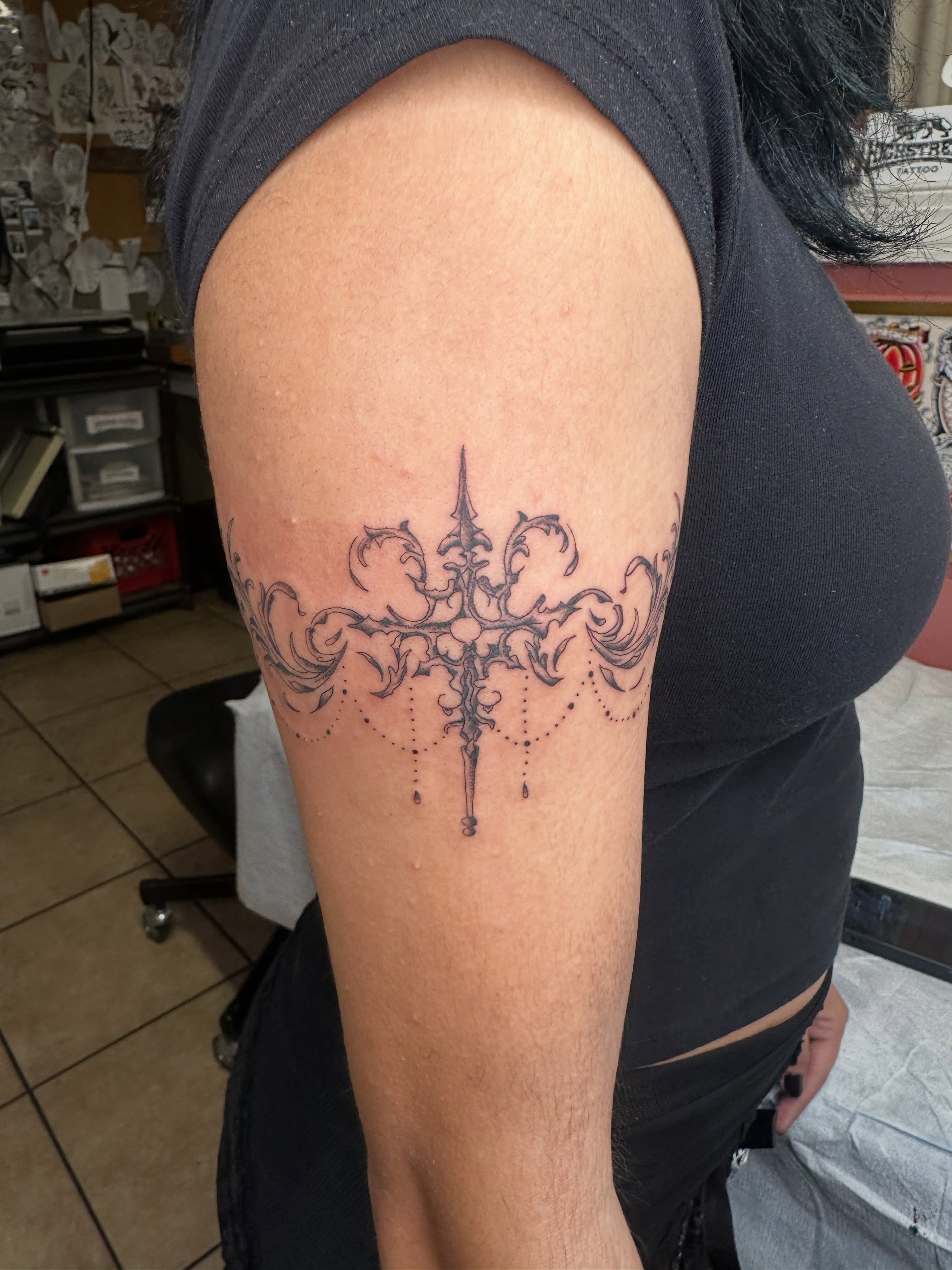 Ornamental chandelier ornamental tattoo on the thigh by Alex Gunshefski