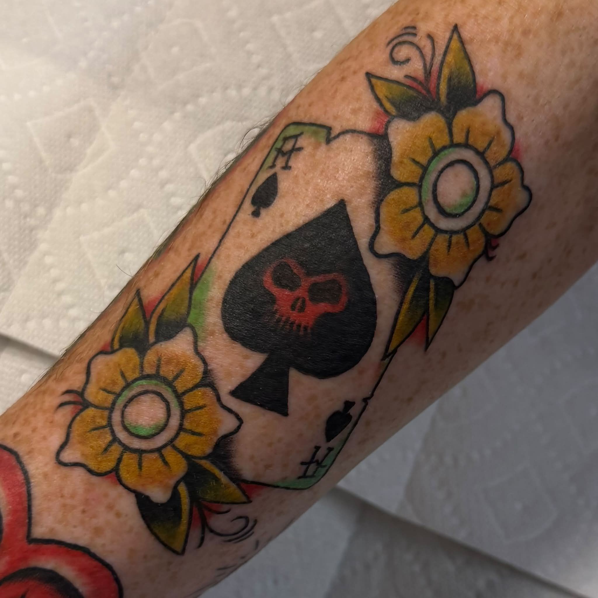 Spade with skull American traditional tattoo on the forearm by Kenneth Prince