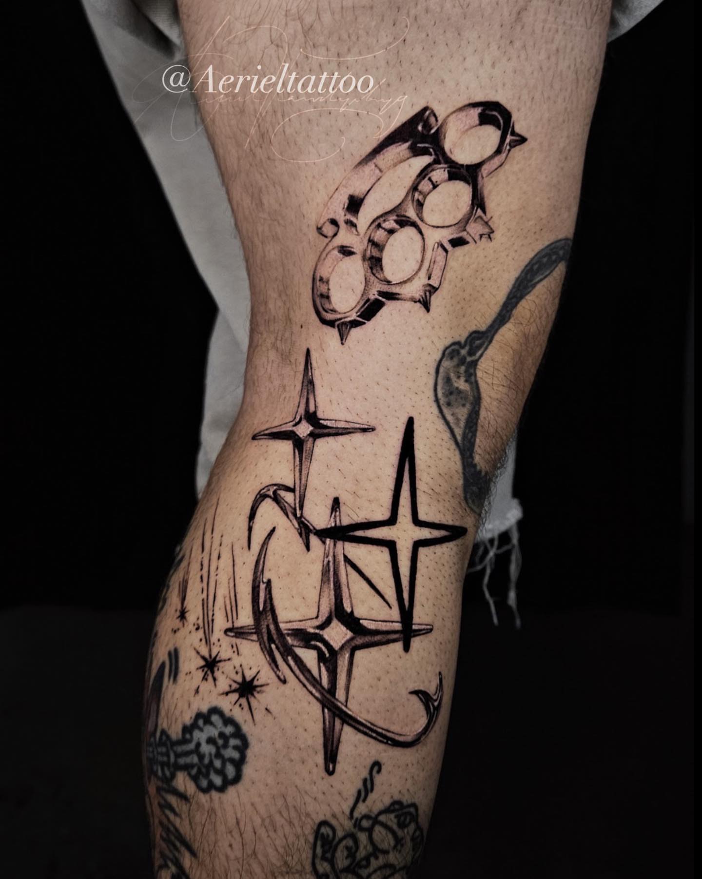 Brass knuckles and stars black and grey tattoo on the forearm by Dallas Tattoo artist