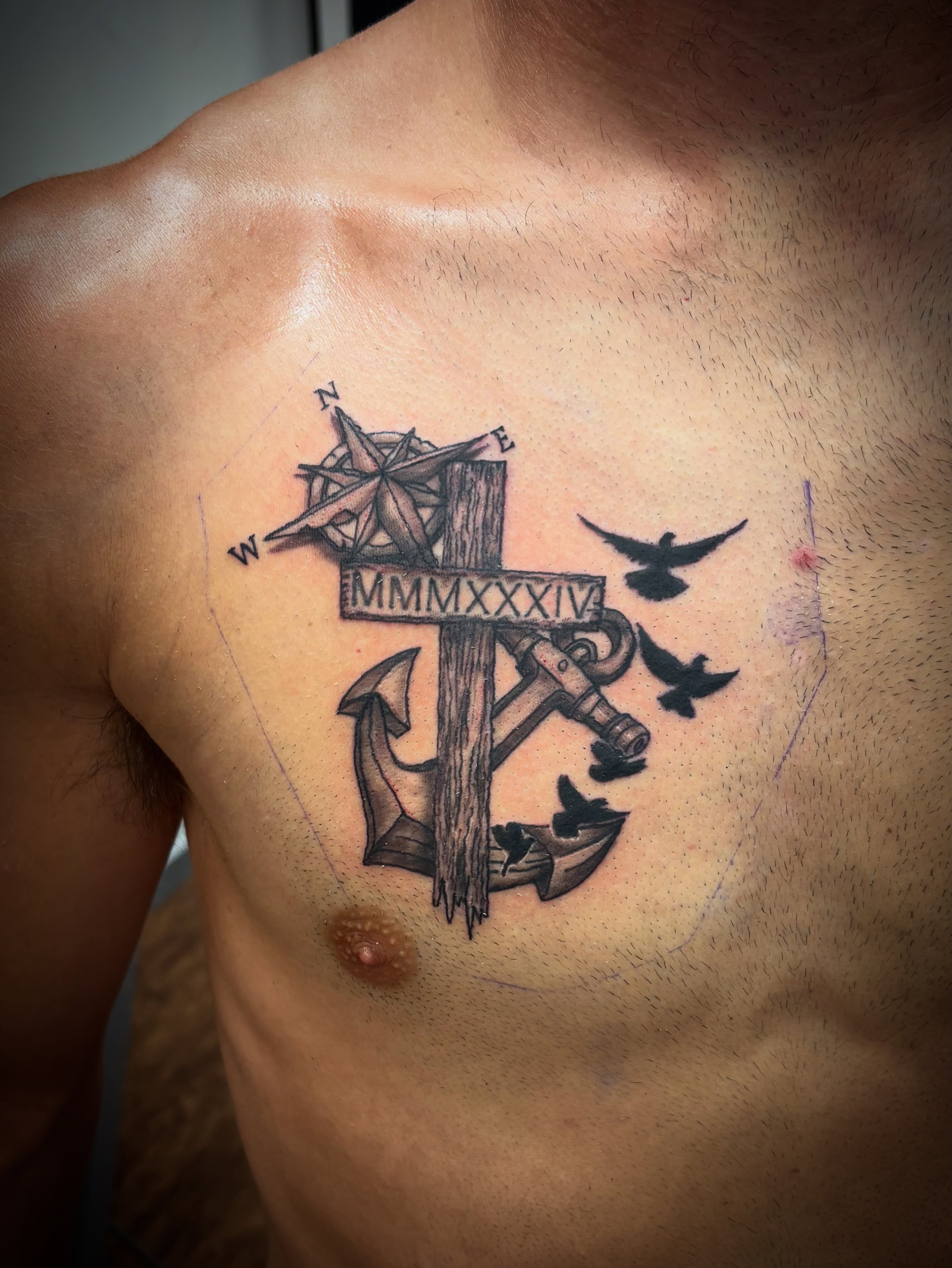 Anchor and compass black and grey tattoo on the chest by Thom Johns-Green