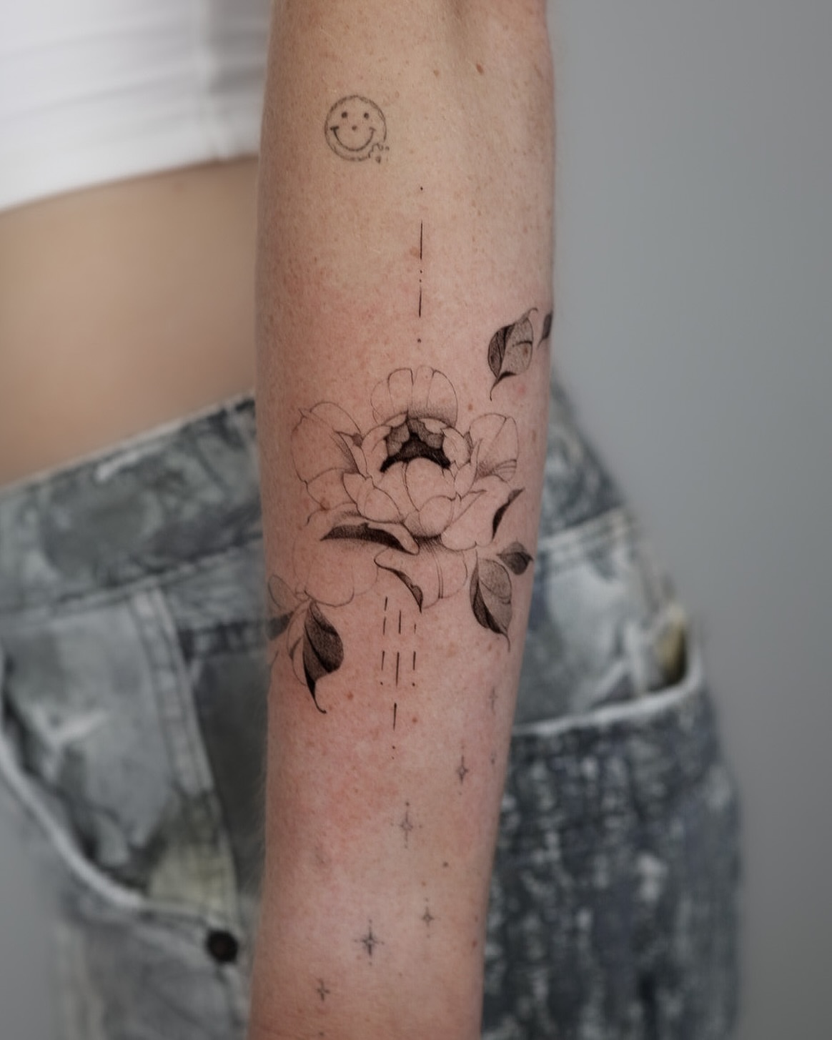 Flower dotwork tattoo on the forearm by Fine Line, New York, New York