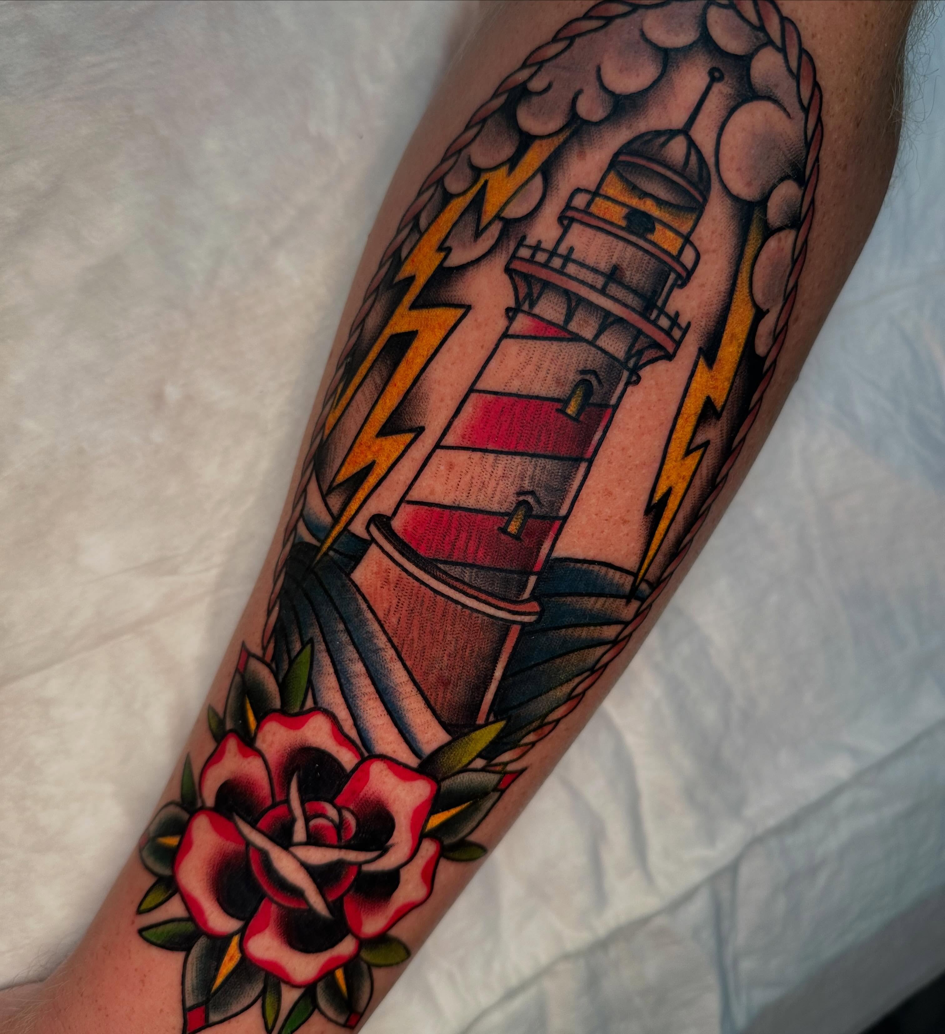 Lighthouse and roses American traditional tattoo on the forearm by Jenni Hand - Tattoo, Maryville, Tennessee